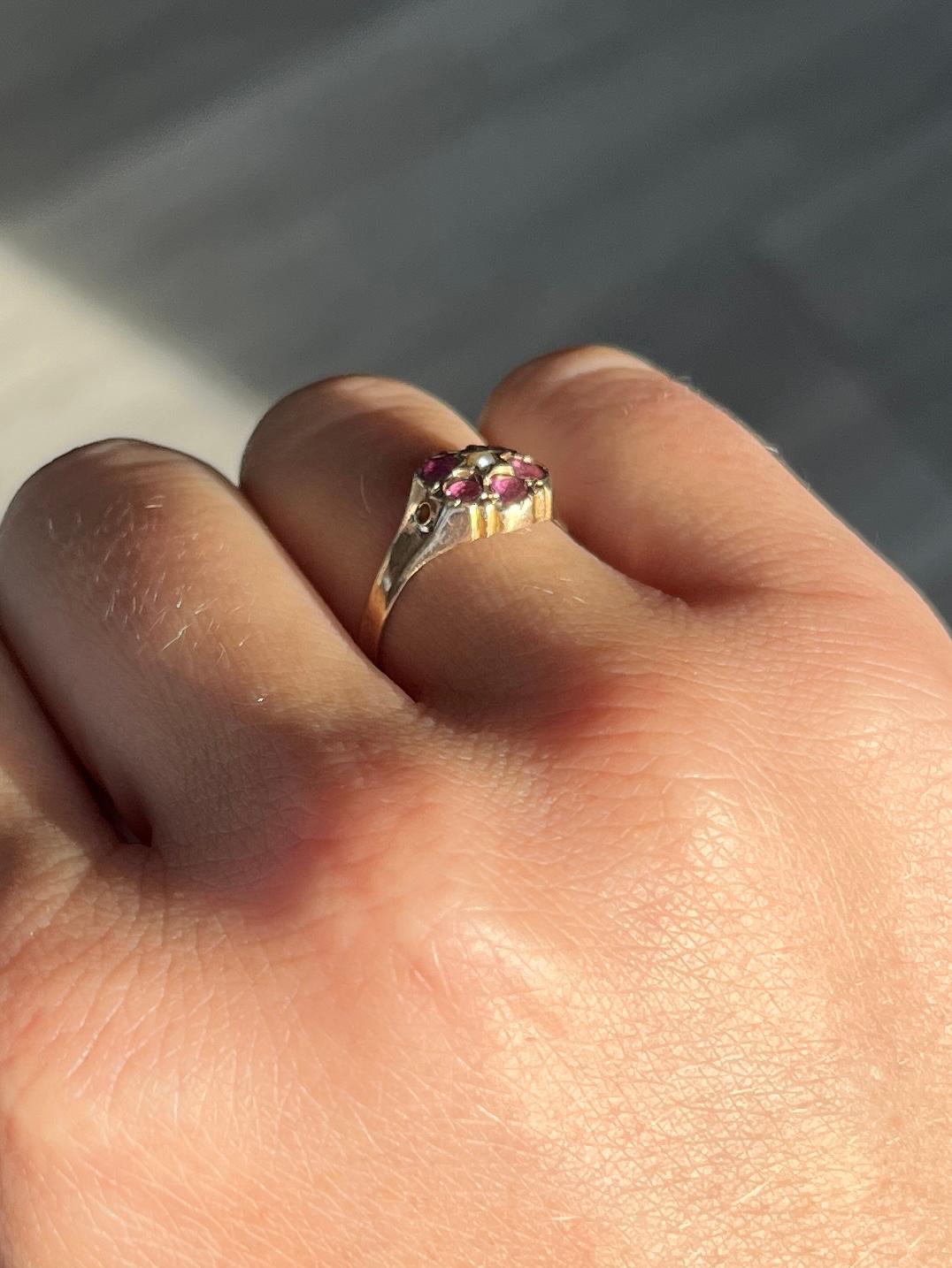 A wonderful amethyst cluster ring with a pearl at the centre. Amethyst total 30pts. Modelled in 9carat gold.

Ring Size: L or 5 3/4 
Cluster diameter: 9mm

Weight: 1.4g