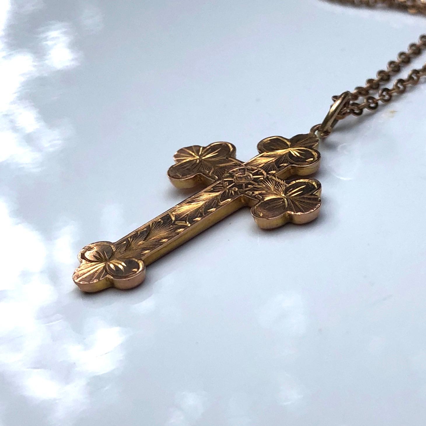 This finely engraved cross and classic chain are gorgeous. The back of the cross is smooth with the hall mark so you could wear it with the engraved detail or the smooth simple side showing. Modelled in 9ct gold. 

Length: 47cm 
Cross Dimensions: