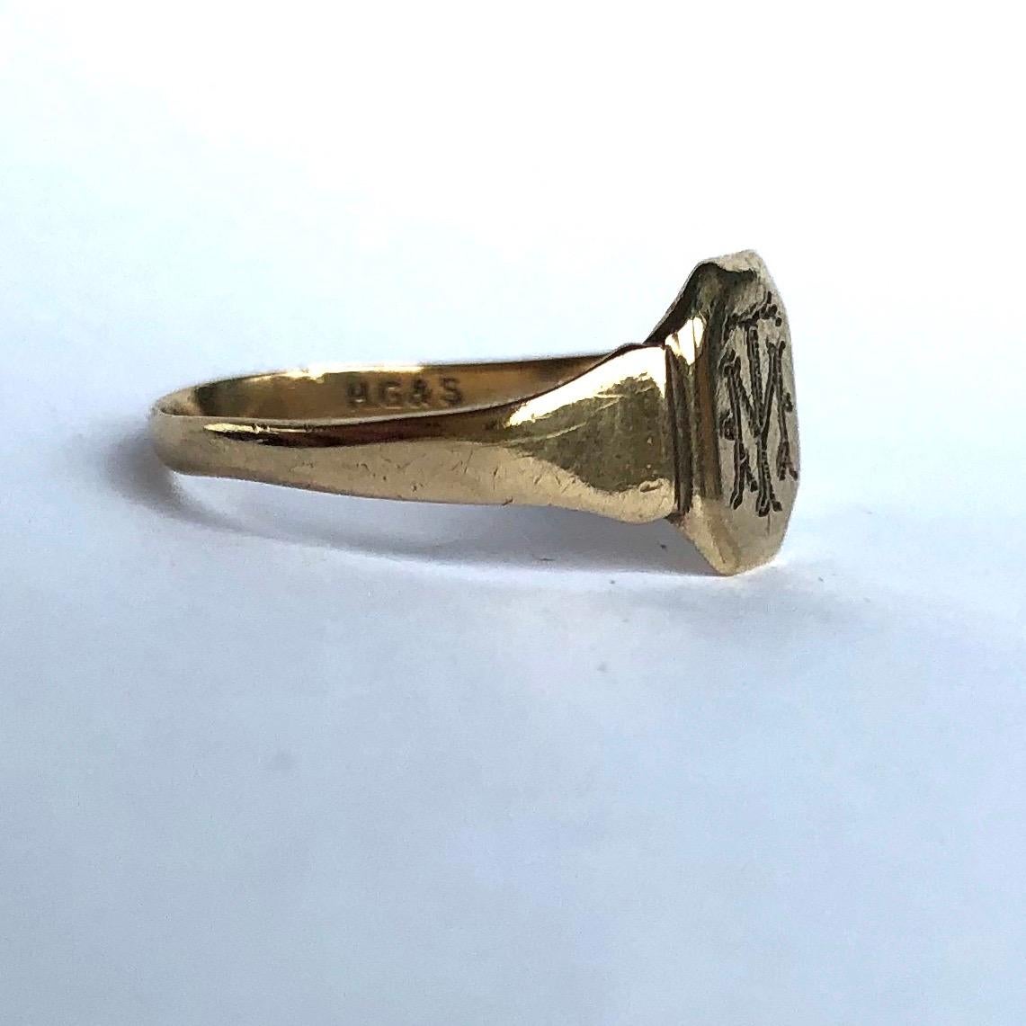 This signet ring is the classic soft octagon shape and is modelled in 9ct gold. The face has initials reading 'T.M' or 'M.T'. 

Size: L or 5 3/4 
Face Dimensions: 8x7mm 

Weight: 1g