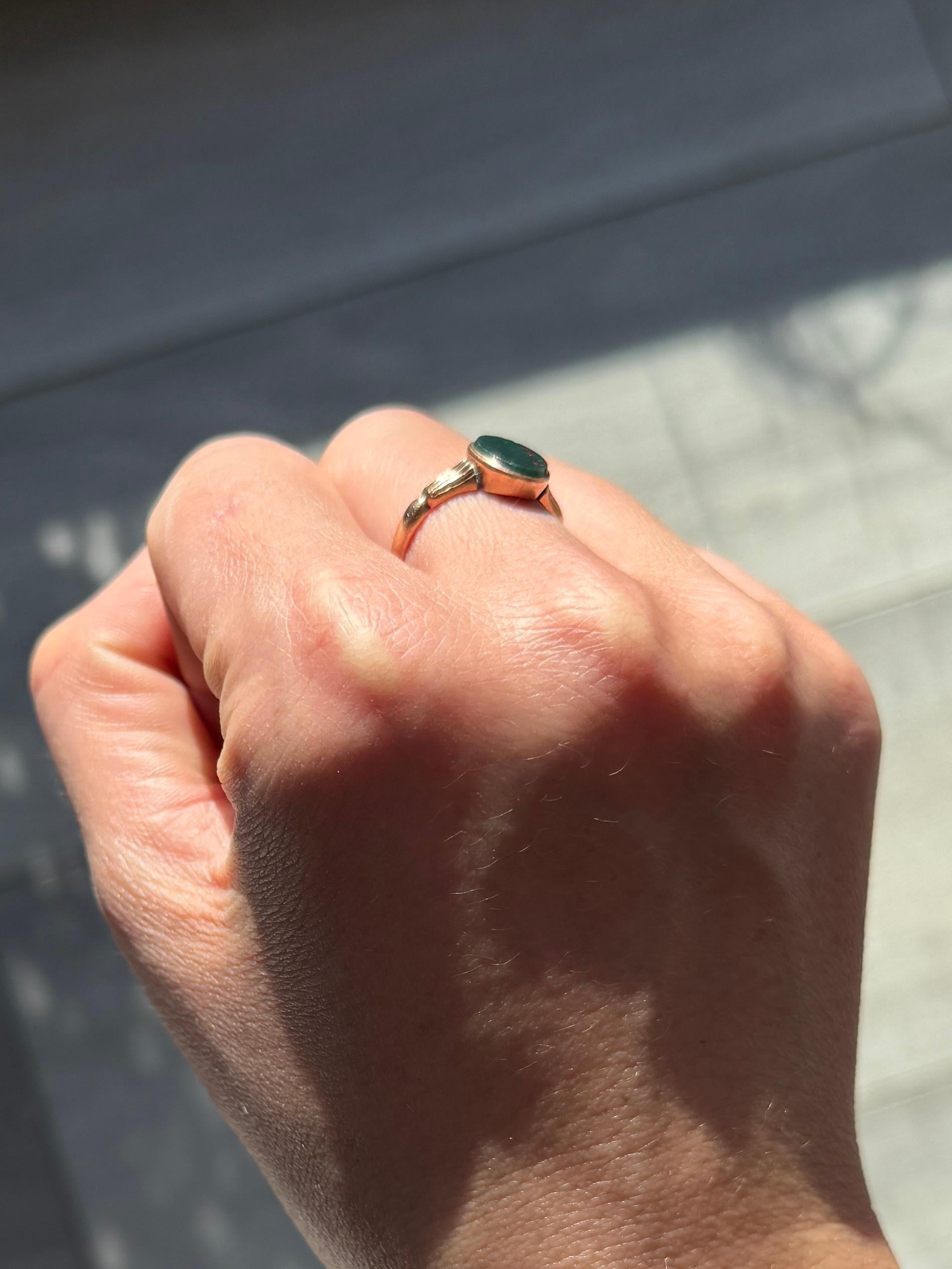 This sweet signet is modelled in 9ct rose gold and is set with a bloodstone. The colour of the ring is very soft rose gold. Fully hallmarked Birmingham 1923.

Ring Size: L 1/2 or 6 
Face Dimensions: 9.5x8mm 

Weight: 1.8g