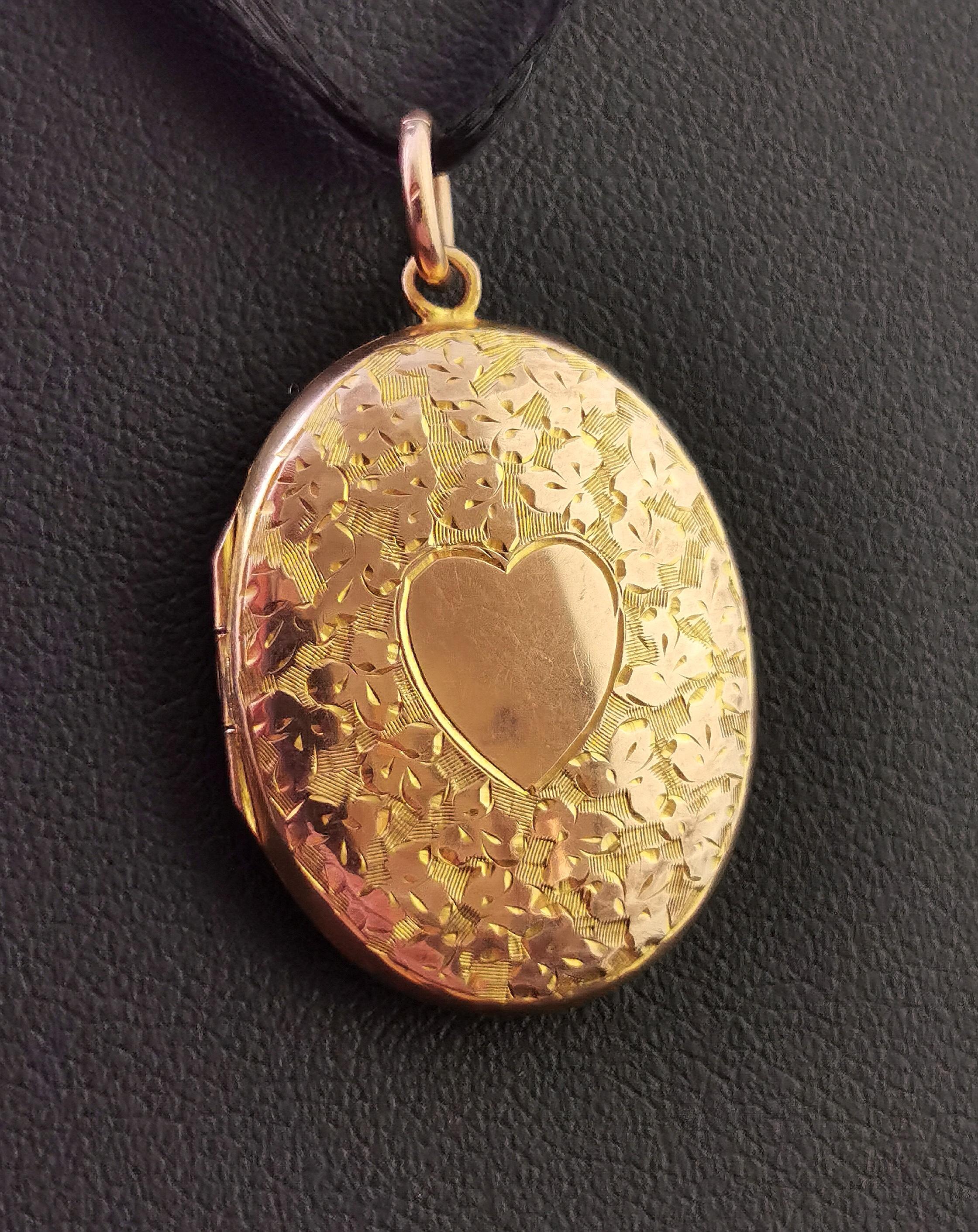 A very pretty antique 9kt Rose and yellow gold locket pendant.

This is a very finely detailed locket with an all over engraved design of trefoil shaped leaves, the front features a sweet heart shaped cartouche which has not been engraved so could