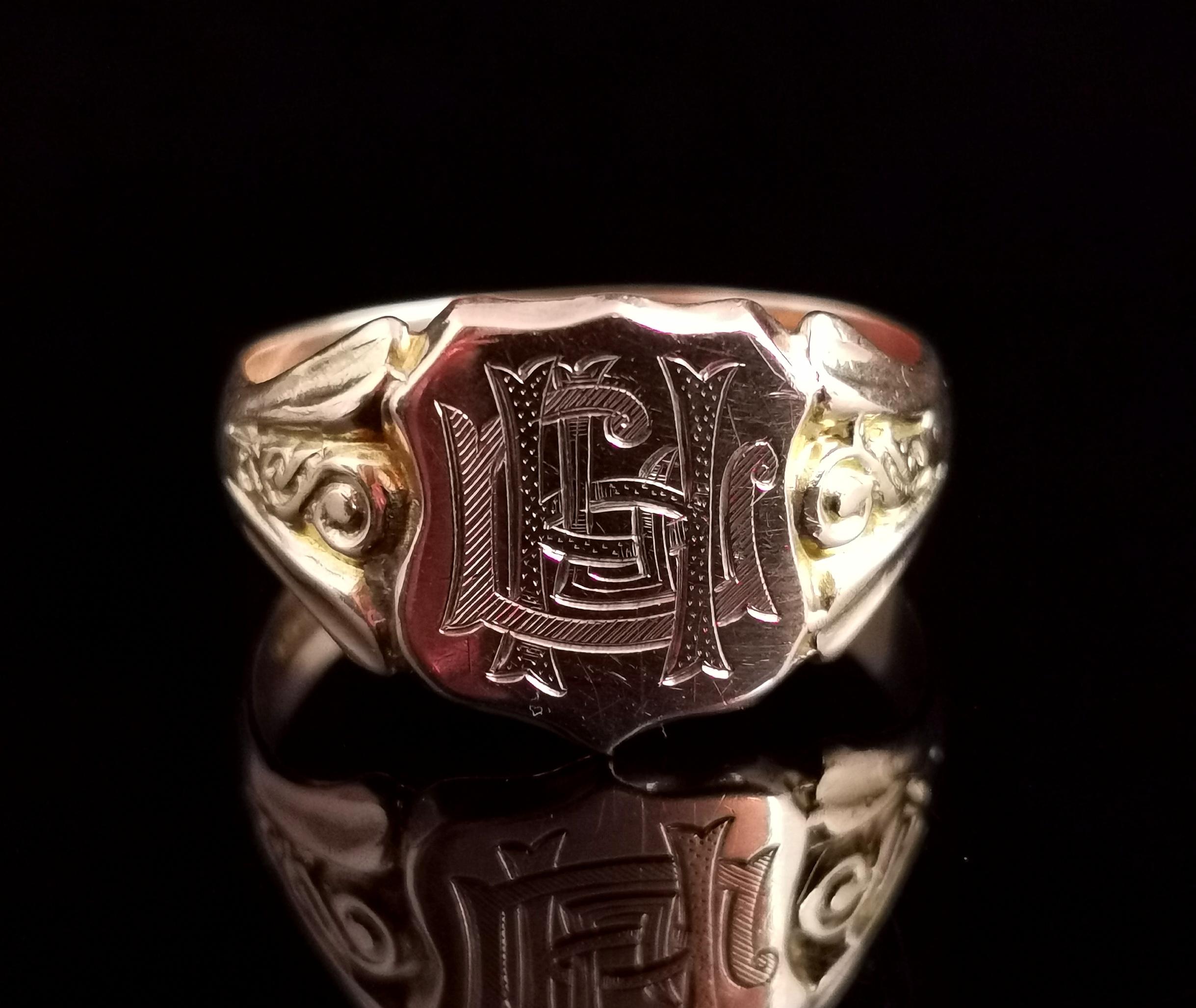 A truly magnificent antique 9 karat Rose and yellow gold signet ring.

It has a shield shaped face with an engraved monogram of initials in heavy gothic script, appears to be HUL, each letter has a different style of engraving.

It has chunky raised