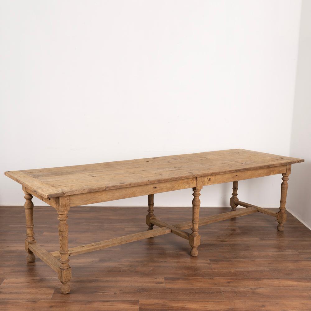 Impressive in size at 9' long, this French oak library or refectory table has six turned legs and supportive stretcher.
There are two drawers, located at each of the narrow ends of the table.
Strong, stable and level, this long dining table is
