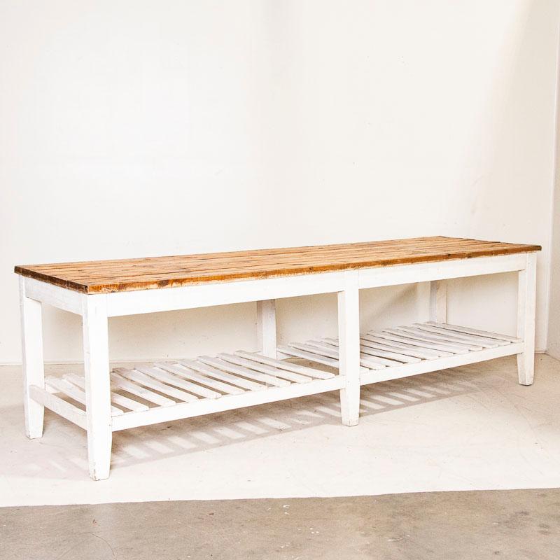 It is the years of use that fill this 9' long work table with character and purpose. The white paint is original, but has been distressed over years of use. The top is made of 8 long narrow planks and was left natural pine, creating a nice contrast