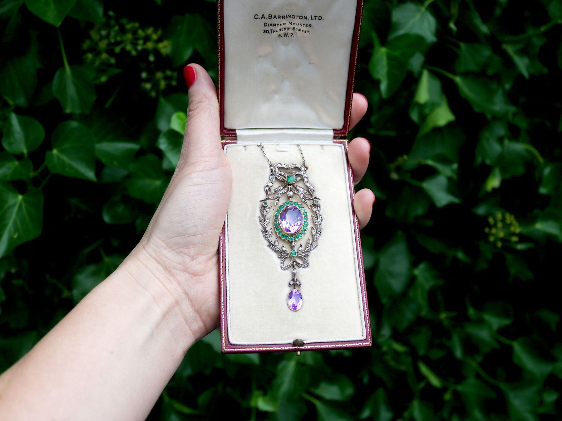 A magnificent and impressive 9.88 carat amethyst, 1.25 carat emerald and 1.13 carat diamond 'Suffragette Colors' pendant in 18 karat and 9 karat yellow gold; part of our diverse antique jewelry and estate jewelry collections.

This large and