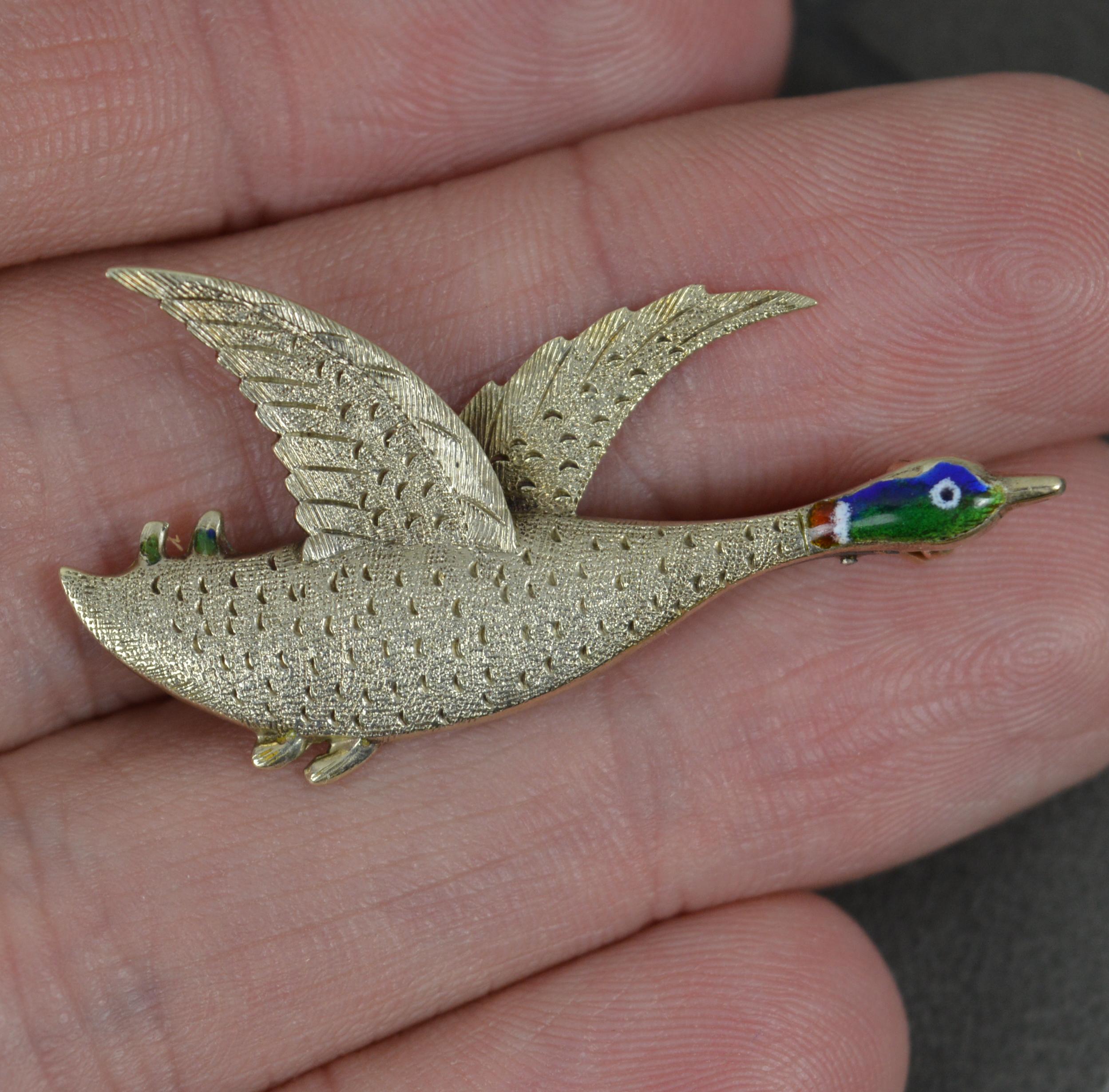 A beautiful antique brooch. c1910.
Solid 9 carat gold example.
Designed as a flying duck. Gold bird and wings with a fine enamelled head.
37mm long. 17mm tall. 2.6 grams.
Condition ; Very good. Clean. Light wear only. Small loss to the enamel.