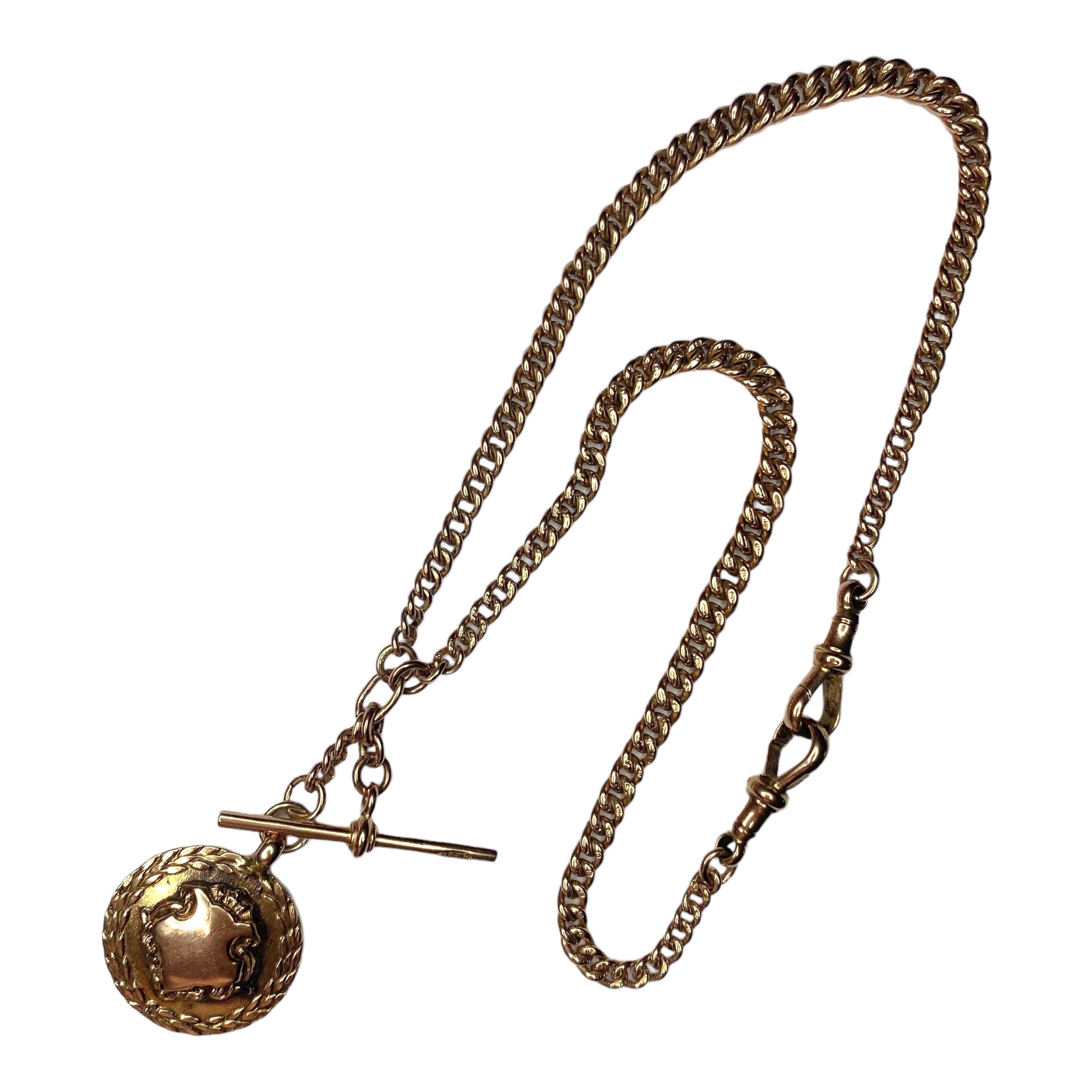 Antique 9ct rose gold Albert chain necklace with two dog clips, a T-bar and a medal. Each curb link on the chain is individually hallmarked for 9ct gold. 
The dog clips and T-bar have the same maker's mark CWSLD. The medal is marked T&S 9ct