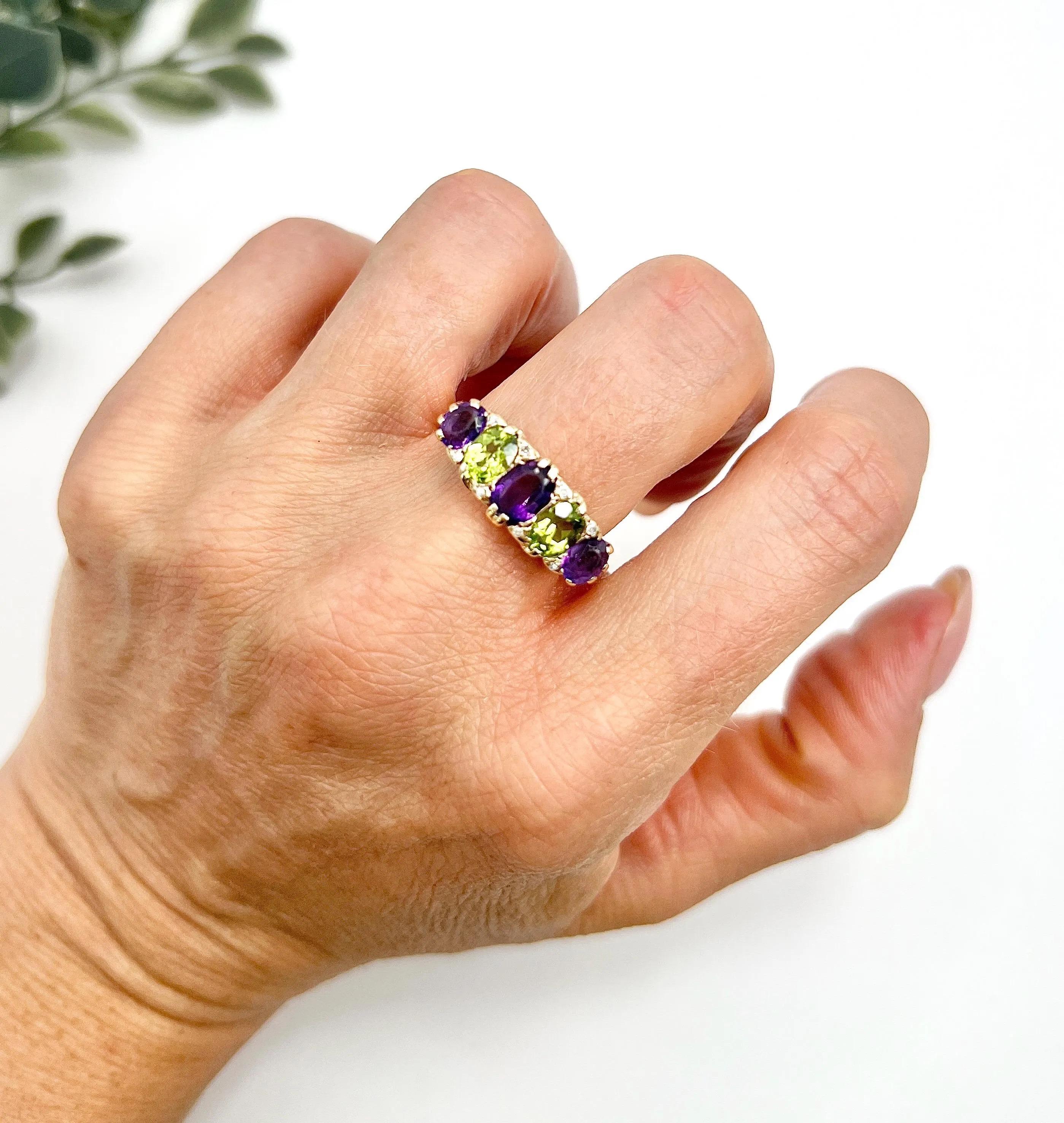 Antique Suffragette Ring 

9ct Gold 

This stunning 9ct yellow gold Edwardian era suffragette ring is a true testament to craftsmanship and history. The ring features a captivating arrangement of alternating amethyst and peridot stones, beautifully