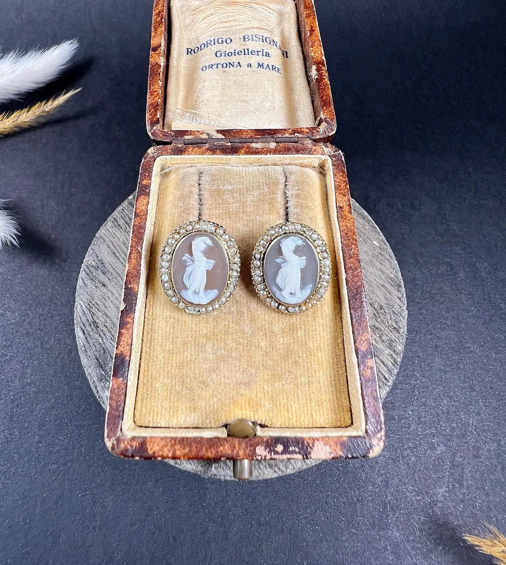 Antique Cameo Earrings 

9ct Gold Tested

Circa 1900

Introducing these exquisite 9ct gold Edwardian shell cameo earrings, featuring a captivating portrait of a lady dancing delicately carved from shell. The intricate portrait is framed in stunning