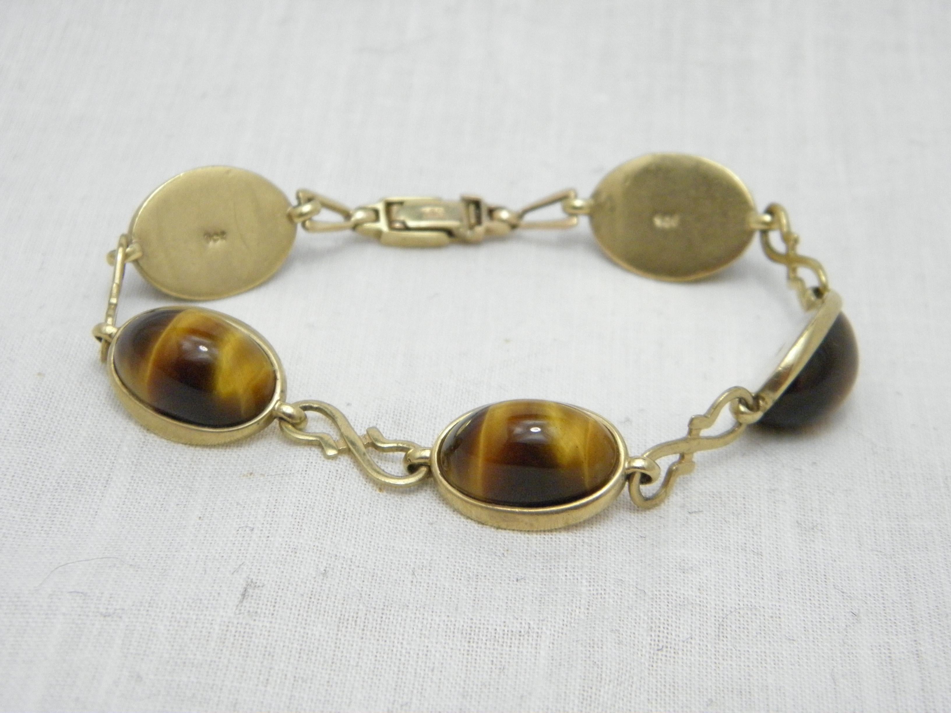 If you have landed on this page then you have an eye for beauty.

On offer is this gorgeous

9CT HEAVY GOLD TIGER'S EYE CABOCHON LINE BRACELET

DETAILS
Material: Solid 9ct (375/000) yellow gold
Gemstones: Lovely oval Tiger's Eye cabacons x 5
Style: