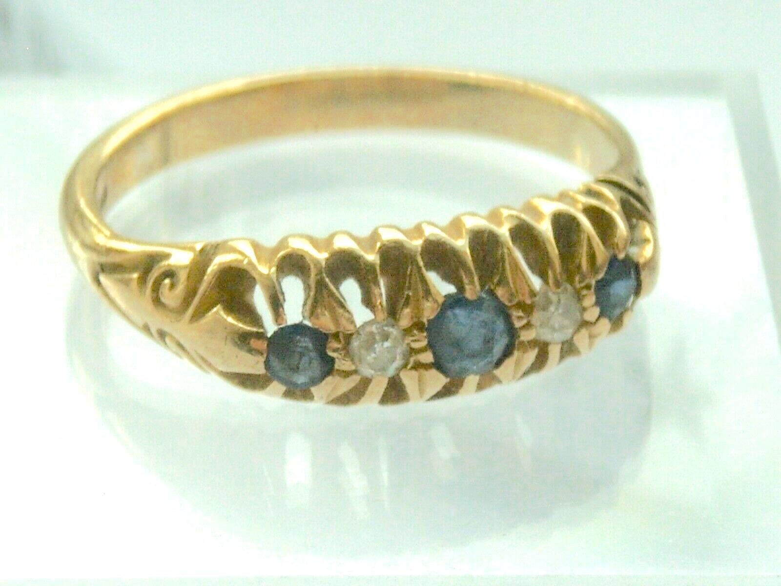 9ct 375 Gold 0.06 Carat Antique Edwardian Diamond Ring
Two Genuine Diamonds 2mm each & Three  3.5mm & 2 x 2.5mm dark blue sapphire stones
Fully Hallmarked by London Assay offices
 Size U.K   P = 17.75 mm (inner diameter)
         U.S   7/5

