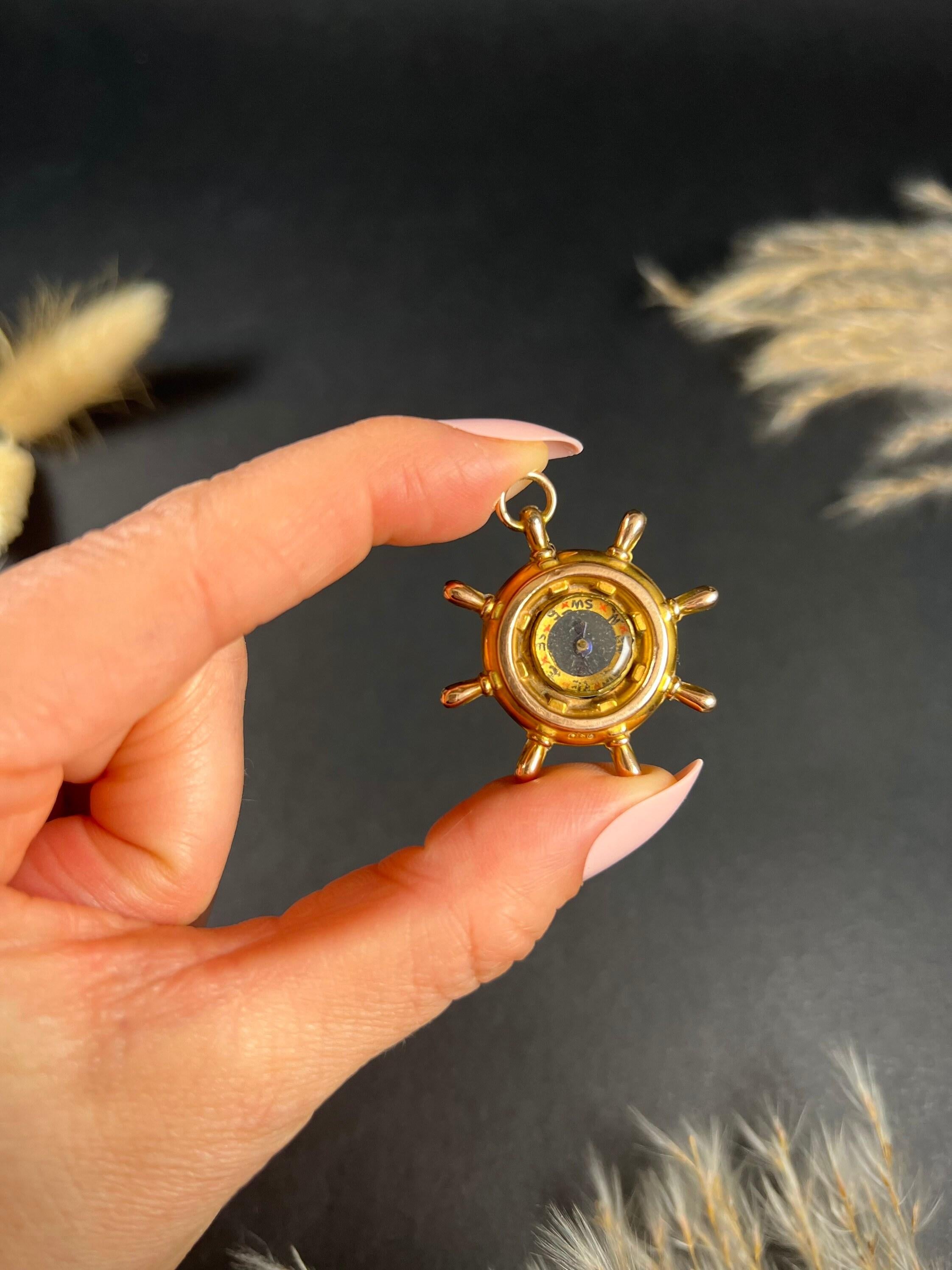 Antique Compass Pendant 

9ct Gold Stamped 

Hallmarked Chester 1919

A truly fabulous find, an antique glass compass set in to a ships wheel. The nautical wheel is crafted in 9ct yellow gold & is reversible. The compass can also be removed from the