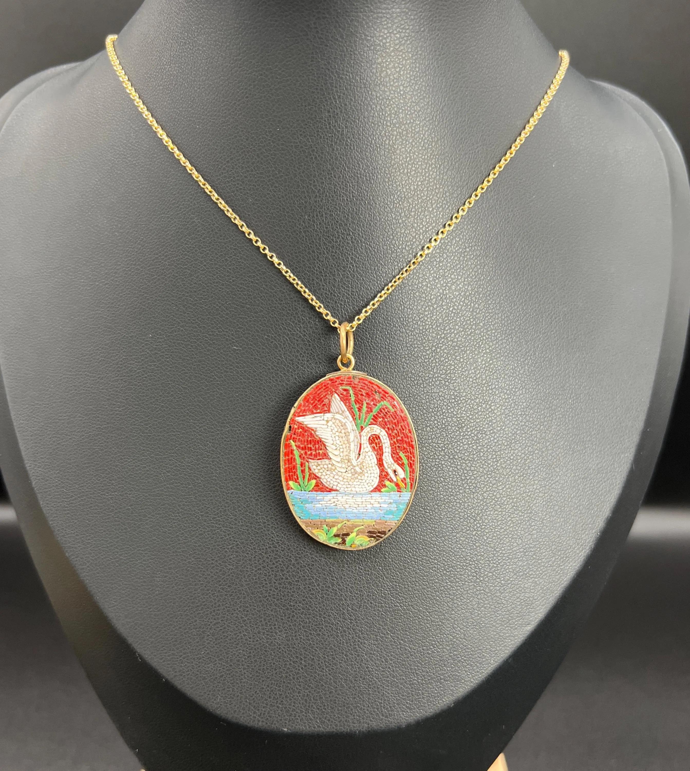 Antique Mosaic Pendant

9ct Gold 

Circa 1870 

Step into a world of elegance with this exquisite Early Victorian handmade micro mosaic pendant featuring a graceful swan gliding serenely on the water. This stunning piece showcases the exceptional