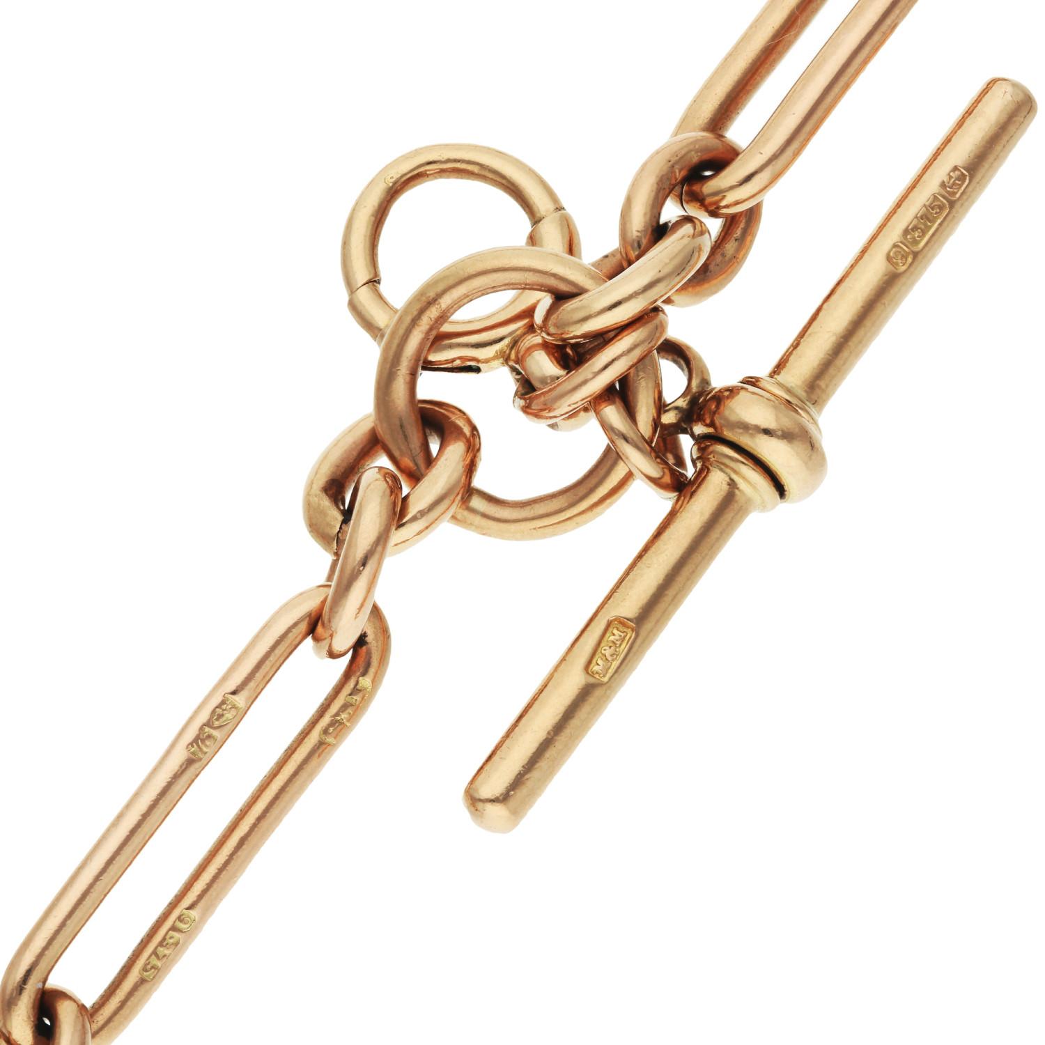 Delve into the opulence of the Victorian era with this captivating Antique 9ct Rose Gold Double Albert Chain, a piece steeped in history and elegance. Expertly crafted in Birmingham, this distinguished chain features the iconic trombone link,