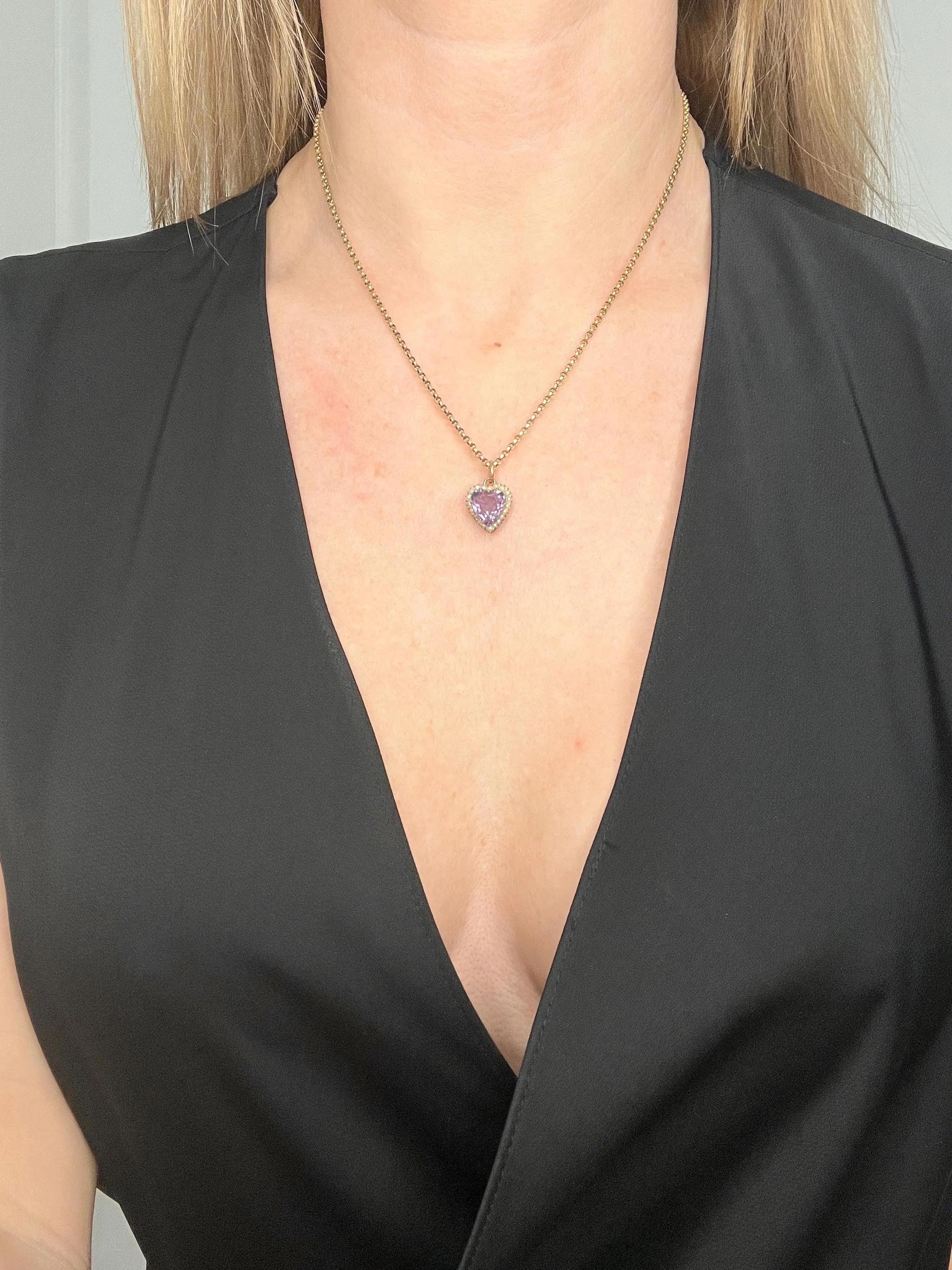 Amethyst & Seed Pearl Heart Pendant 

9ct Rose Gold 

Circa 1900

*THE GOLD CHAIN IS AN ADDITIONAL PURCHASE. 

Introducing this exquisite 9ct rose-gold Edwardian heart-shaped pendant, featuring a stunning faceted amethyst haeart delicately framed