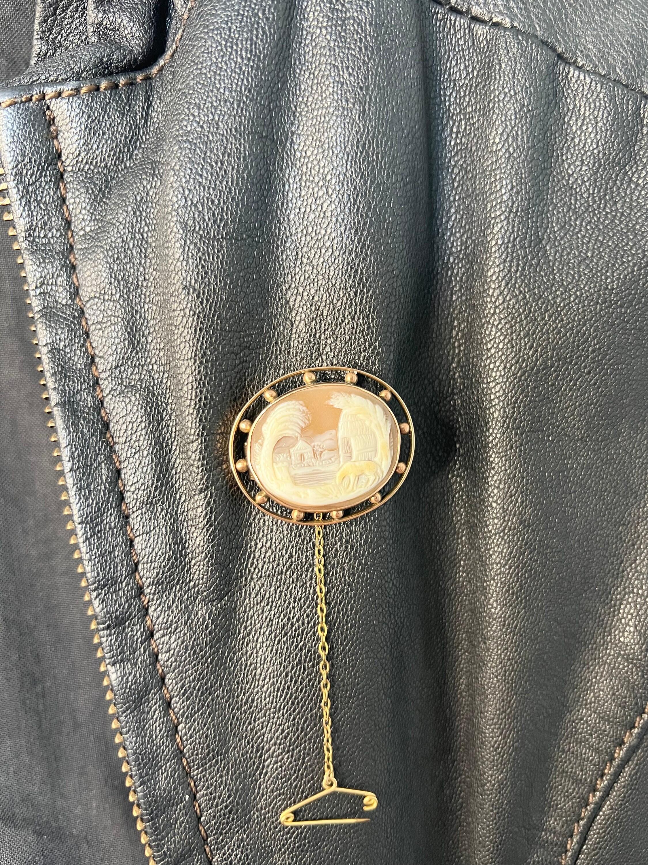 Antique Cameo Brooch

9ct Rose Gold Stamped 

Circa 1900

A beautiful, Edwardian piece. Decorated with a pretty, shell cameo of a landscape scene with lovely palm trees, buildings & a horse. The safety chain is removable & could easily be converted