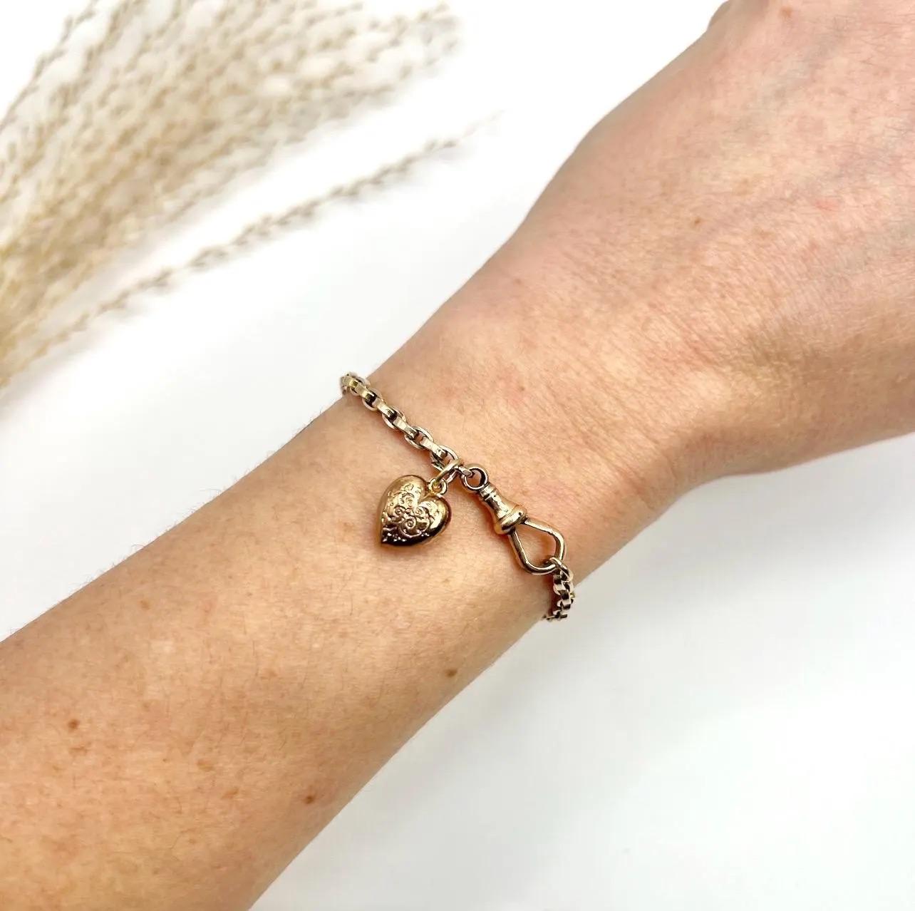 Antique Gold Bracelet 

9ct Rose Gold

Circa 1890

Introducing a stunning piece of Victorian-era jewellery - a 9ct rose gold rolo link bracelet with a swivel clasp and engraved heart charm. The bracelet showcases a timeless design that has been