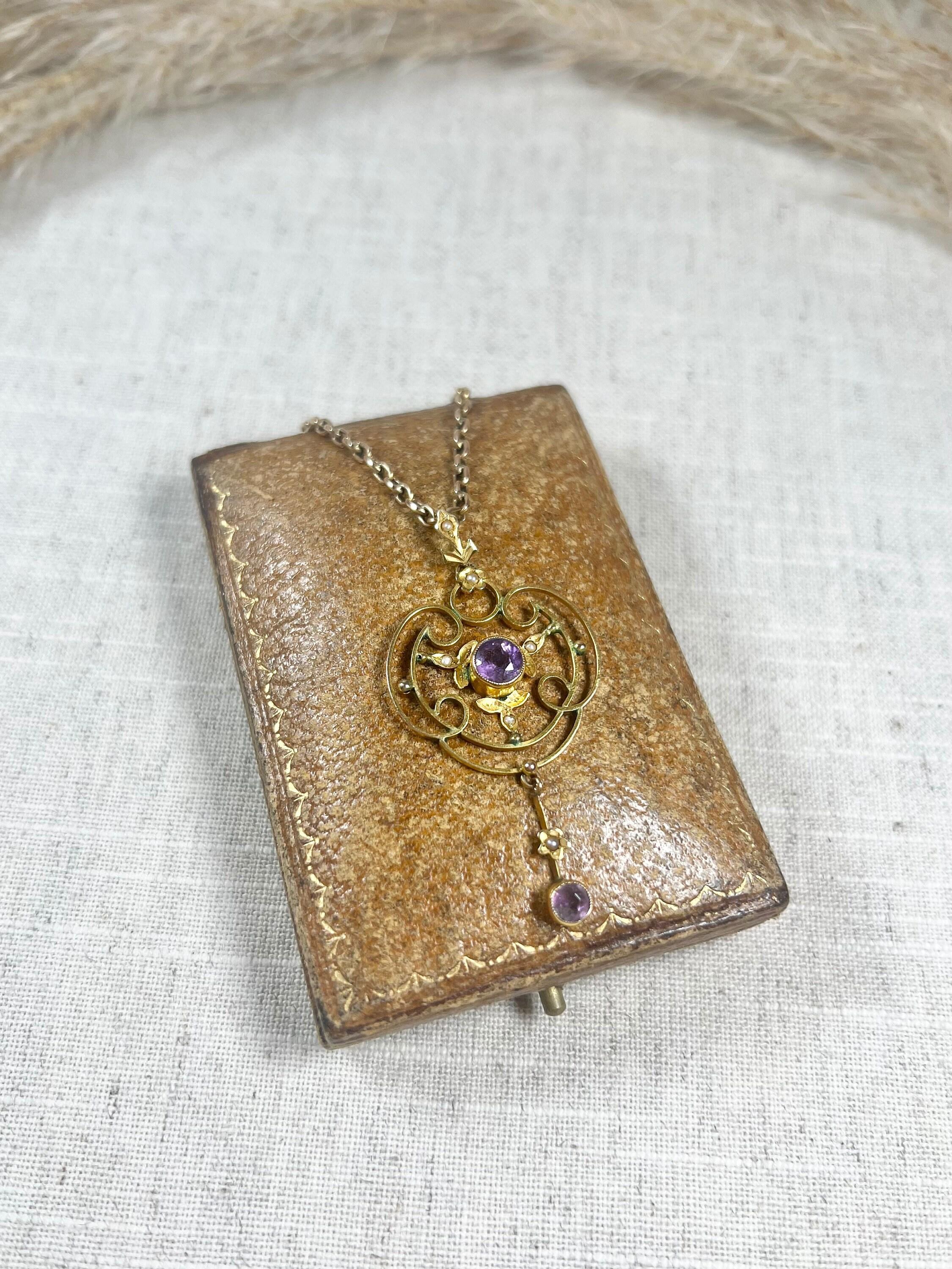 Antique Amethyst Pendant 

9ct Yellow Gold Tested

Circa 1900

This exquisite Edwardian pendant crafted from 9ct yellow gold is a true work of art. The open work design adds a delicate touch to this stunning piece of jewellery, while the central,