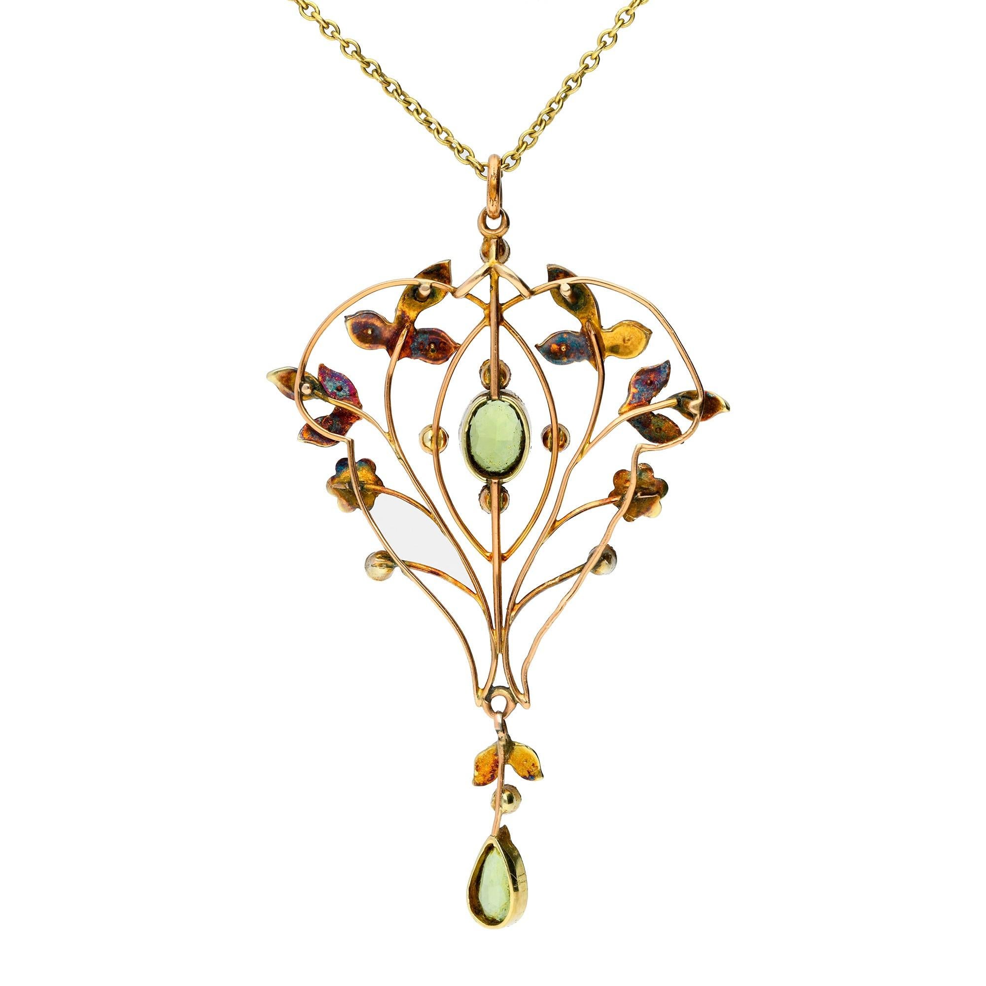 This lovely early 20th century pendant, with floral inspiration. Decorated with foliate motif, set with shimmering split pearls and vivid peridot highlights, suspended from a yellow metal chain.

A lovely piece, that would be the perfect bridal