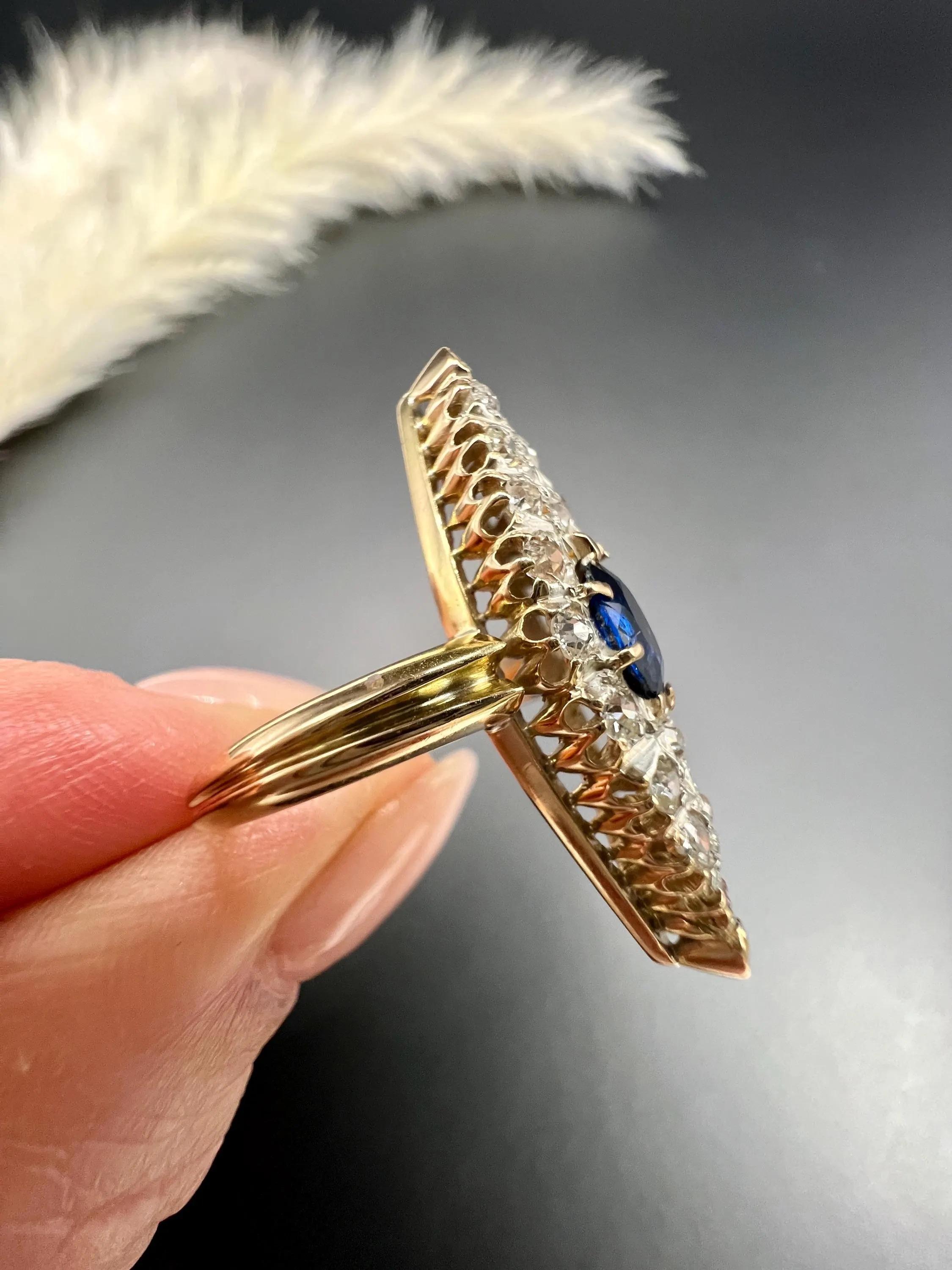Antique Sapphire Marquise Ring 

9ct Gold Tested

Circa 1880s

This stunning Victorian ring is crafted from 9ct gold and features a marquise shape, with an exquisite oval, faceted natural sapphire at its centre. Surrounding the sapphire are dazzling