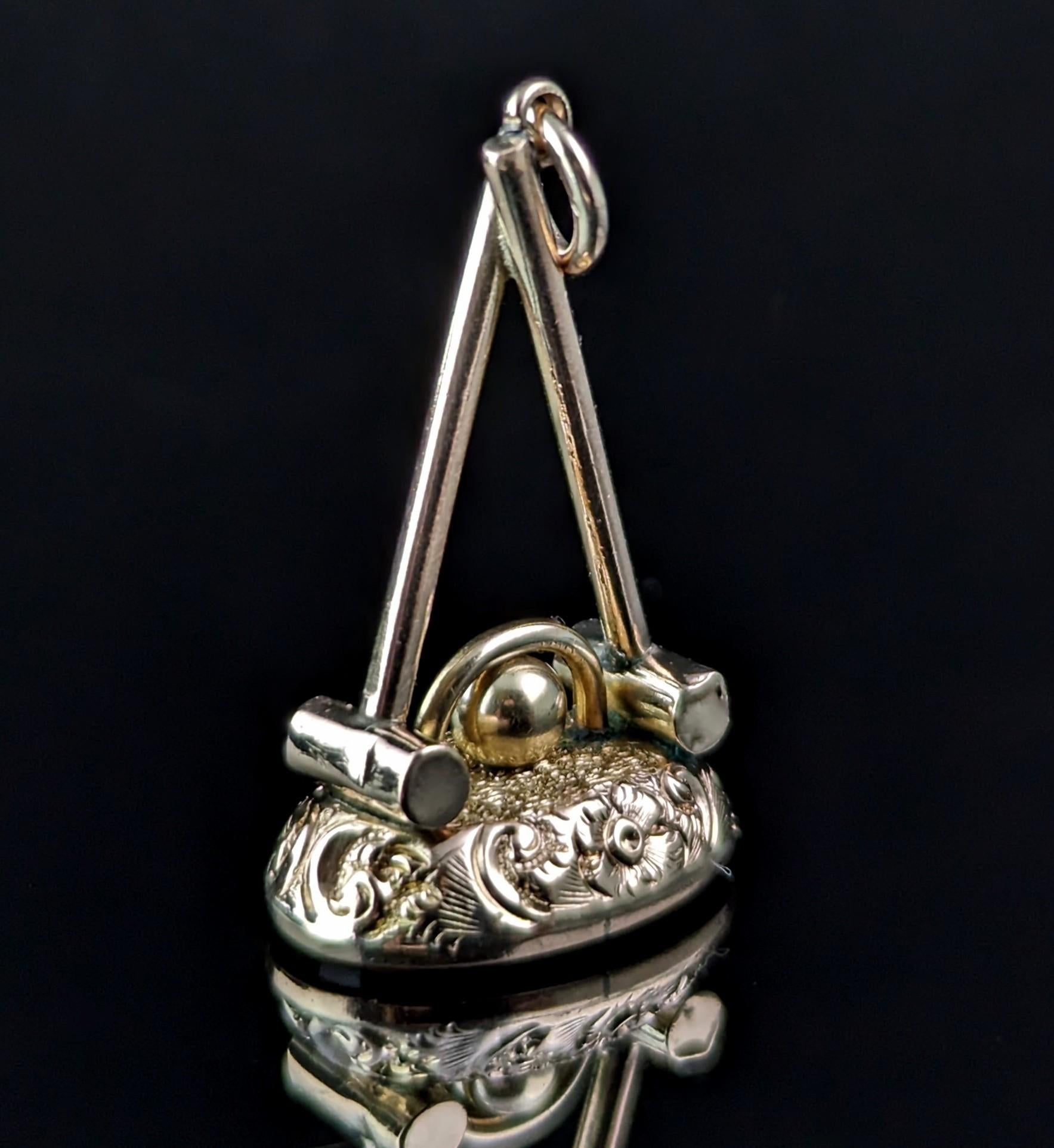 This antique 9ct gold seal fob is designed a little differently and is really very charming!

It is designed as two crossed croquet mallets with a hoop and ball to the base, resting on top of the chased gold which houses a lovely rich red oval