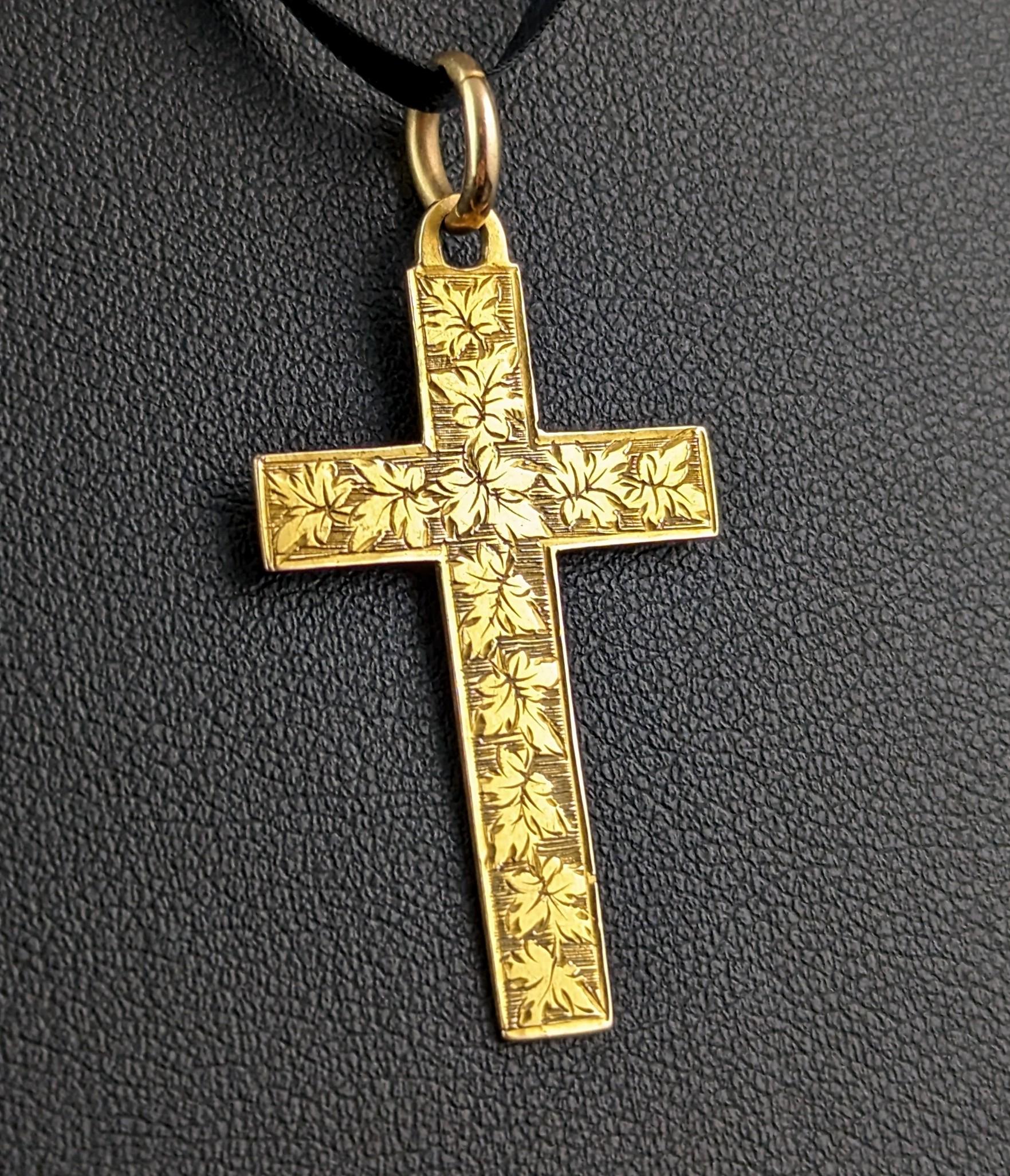 A gorgeous antique 9ct gold cross pendant.

It is a medium sized cross, lightweight and easy to wear with a beautifully engraved front and smooth polished back.

This attractive hand cut antique gold cross would be the perfect addition to your