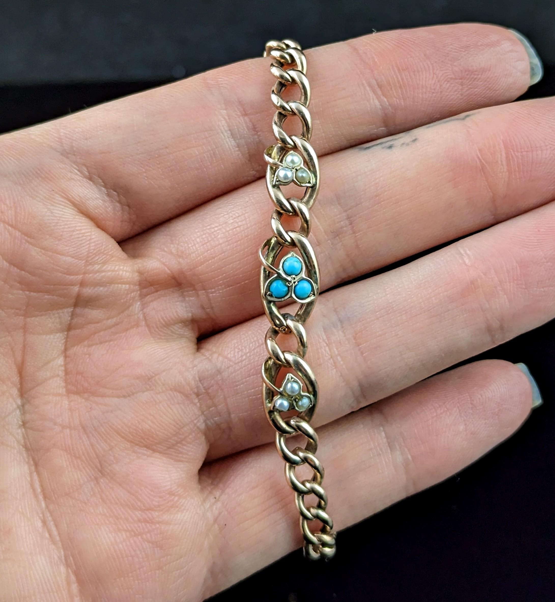 gorgeous antique Edwardian curb bracelet.

This has a pretty leaf design to the front of the bracelet with three separate leaves, the middle one set with small turquoise cabochons and the other two set with seed pearl.

It has 9ct rosey gold curb