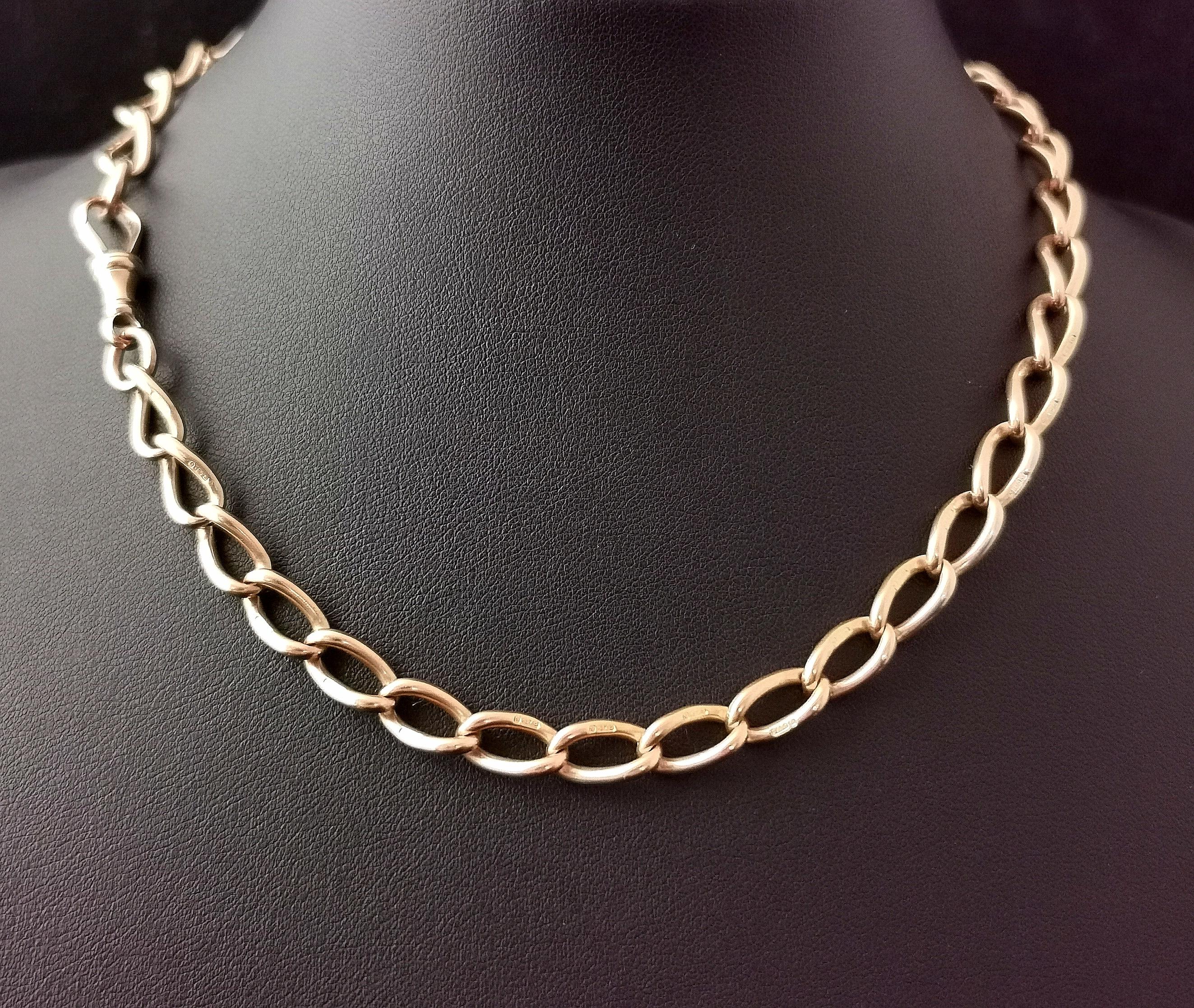 A gorgeous antique 9kt Rose gold single Albert chain or watch chain.

It has beautiful elongated curb links with a light rosey overtone, each individually stamped for 9kt gold, these stretched curb links make for a wonderful design one of our