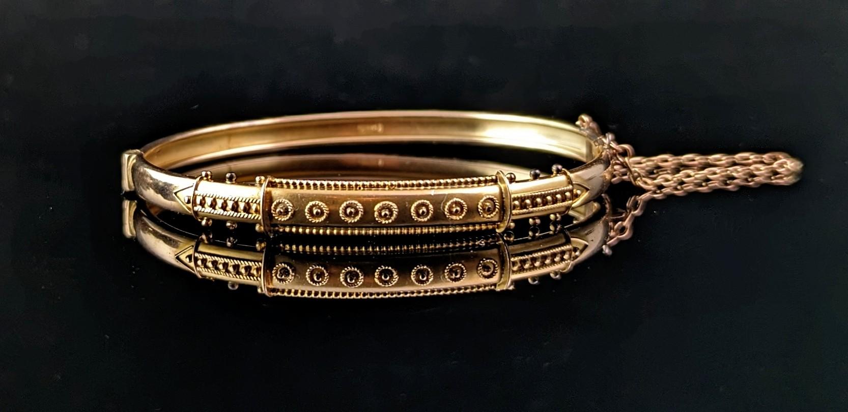 The most beautiful antique Victorian 9ct gold, Etruscan revival bangle.

It is a lovely rich warm gold which adds to its regal Etruscan manner, the front of the bangle is intricately designed with delicate Cannetille detailing showcasing the fine
