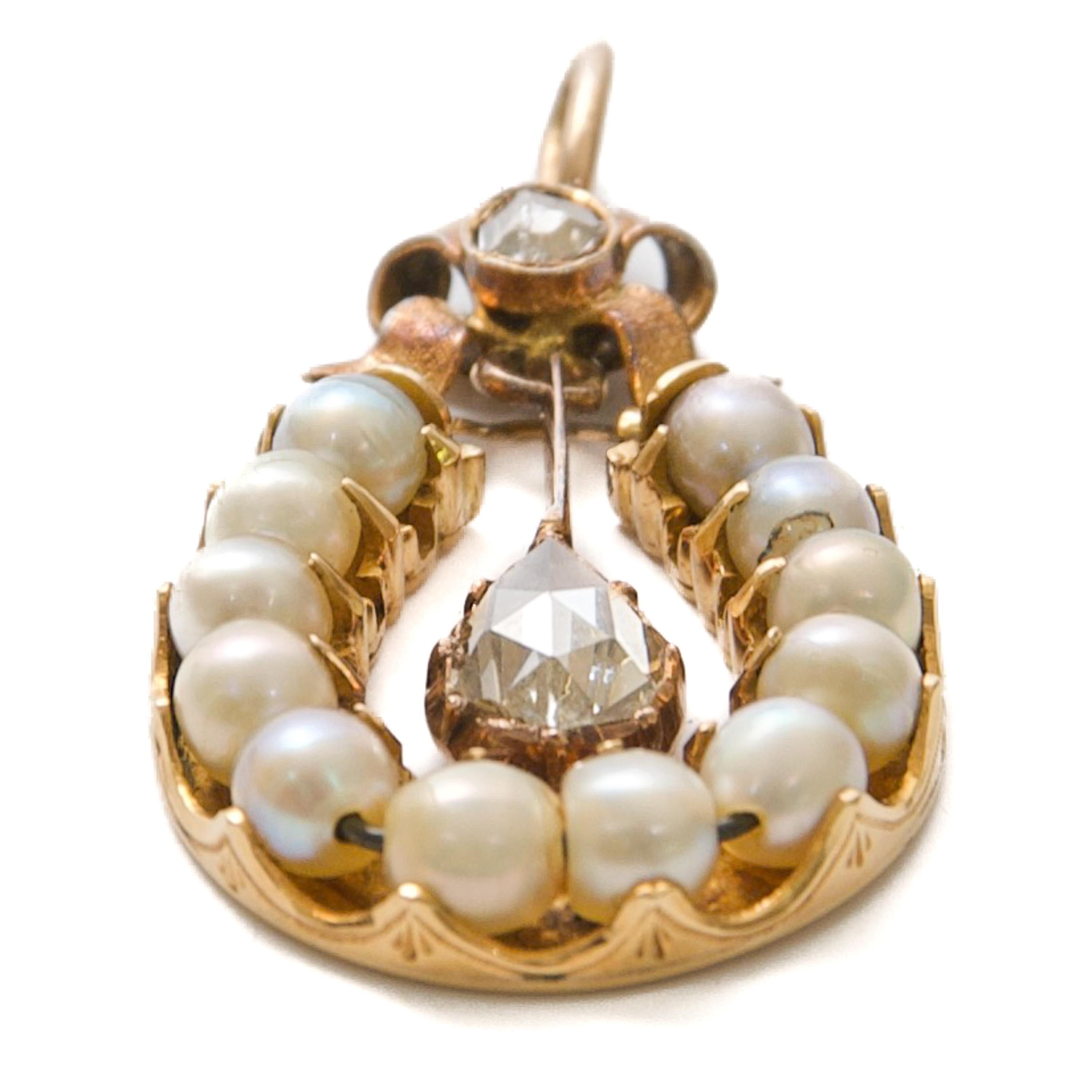 This gorgeous antique pendant is a stunning example of fine craftsmanship and elegant design of the 19th century, crafted in 9 carat gold and created in the shape of a horseshoe. 

The charming gold bow at the top of the horseshoe is decorated with