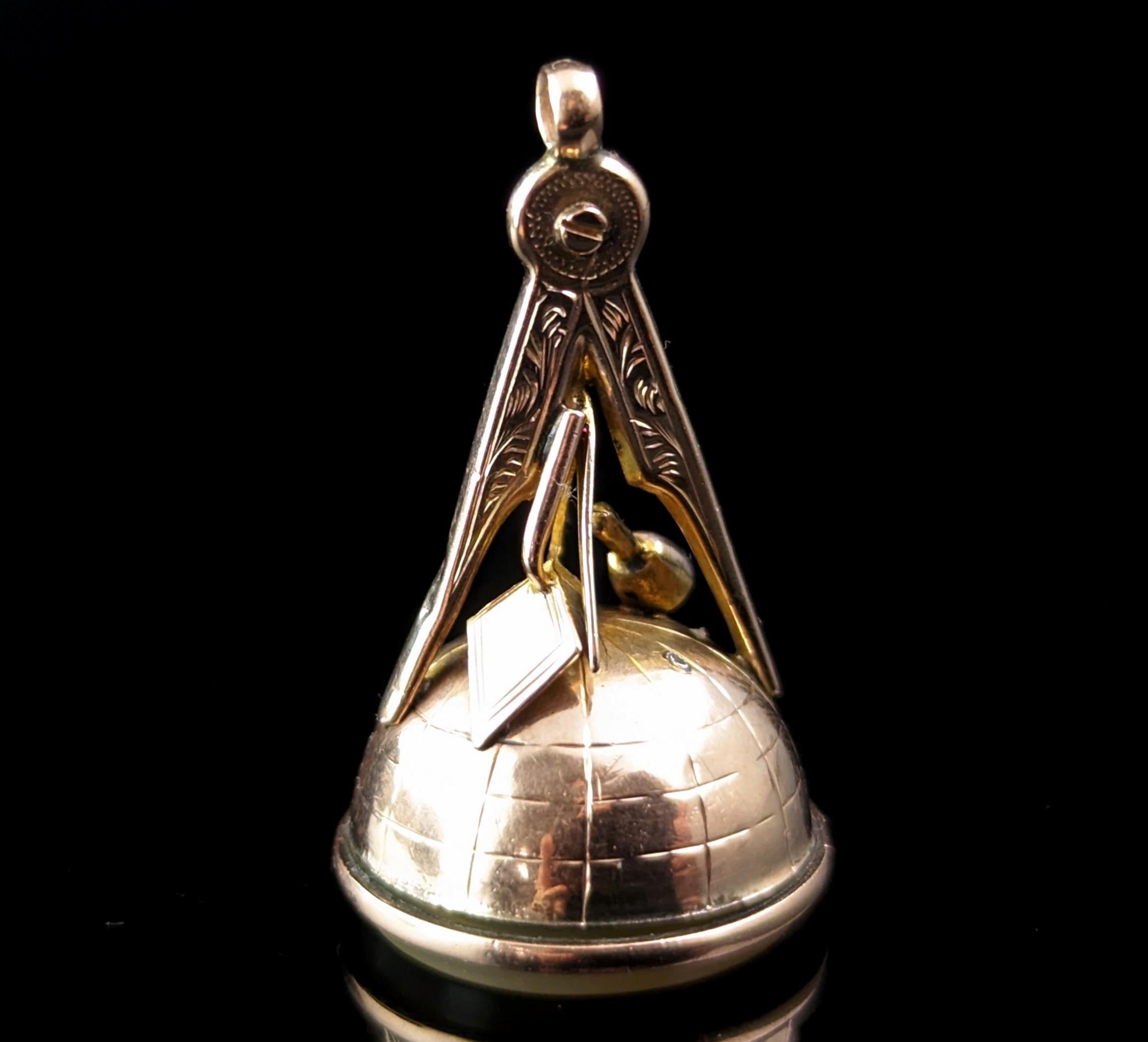 An interesting and attractive antique Masonic seal fob pendant.

This was designed to be worn on an Albert chain also known as a pocket watch chain.

It is very well designed with the top made up of 9ct gold traditional Masonic symbols of a compass,