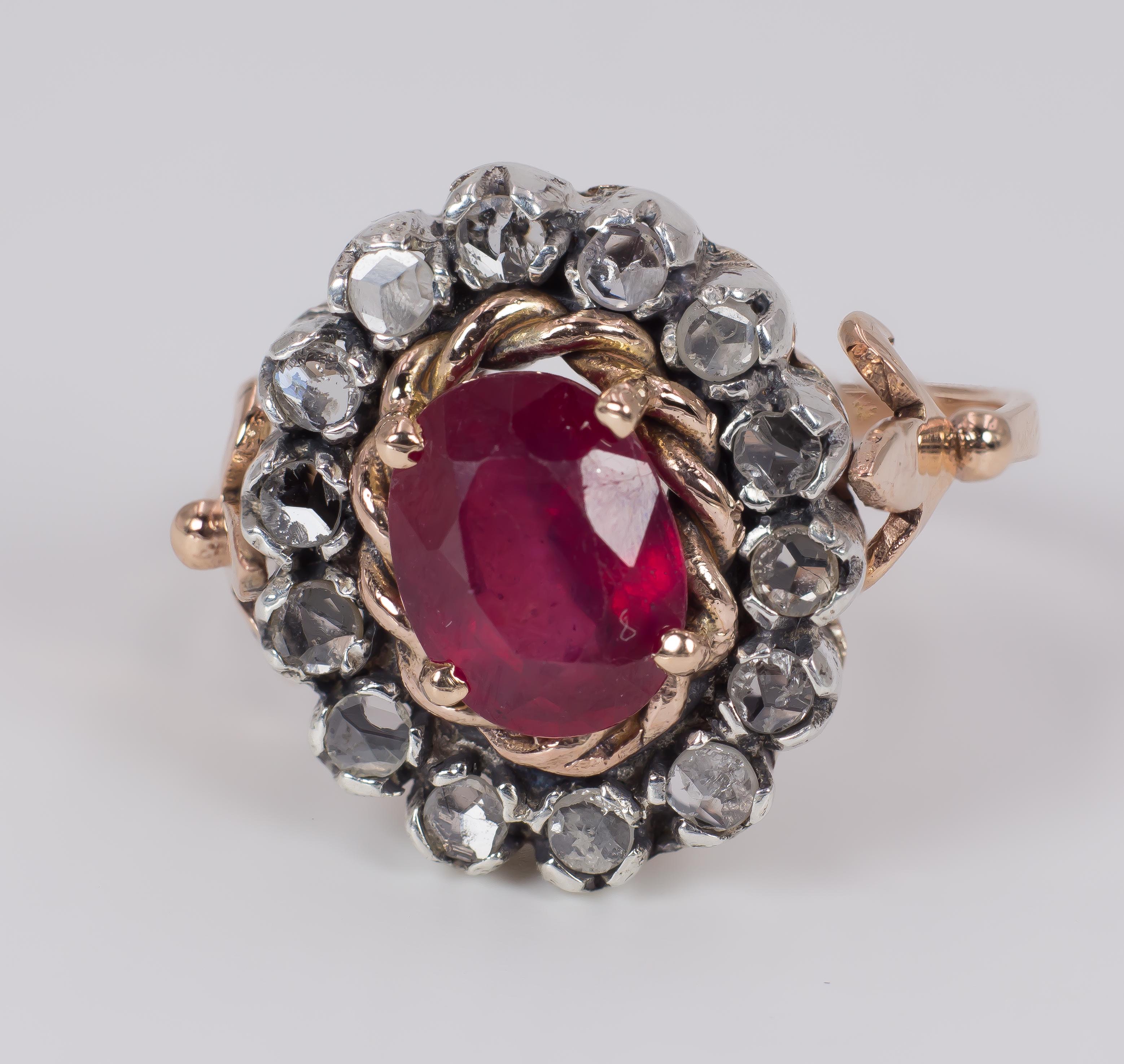 An antique gold, ruby and diamond ring, dating from the 1940s.
Modelled in 9K gold throughout, it has a superb main stone, a 2ct red ruby, surrounded by a crown of beautiful rose cut diamonds.
The entire ring is held up by a shank that end in an