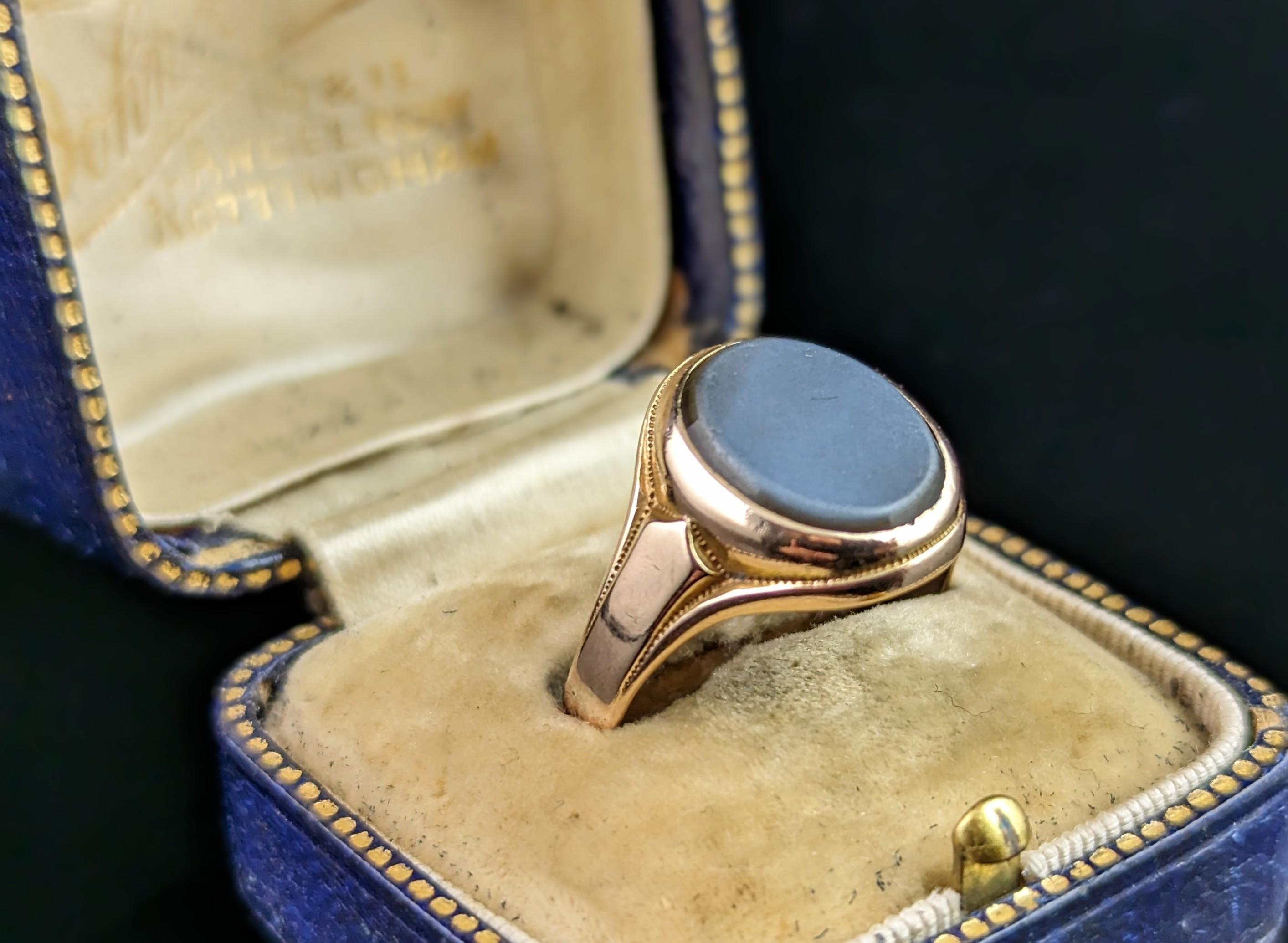 This handsome antique, Art Deco era 9kt gold and Sardonyx signet ring is a real treat.

It has an oval black Sardonyx bezel set to the front, this has a light white overlay over the front and has not been carved so could be personalised if