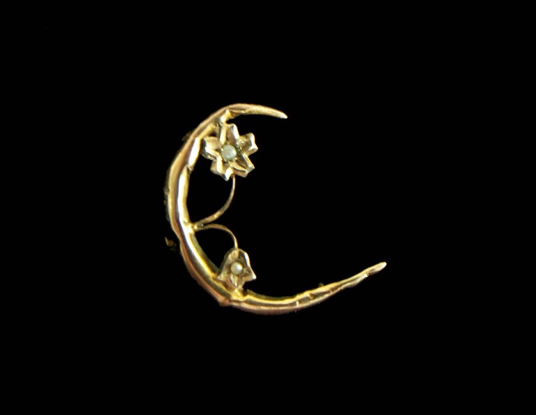 Antique 9K yellow gold and seed pearl crescent brooch with flower - small size - set with 2 natural pearls (each measuring 1 mm. in diameter) - 'C' catch - round hand made hinge and pin - stamped 9K and signed on the back ('A' in a shield -