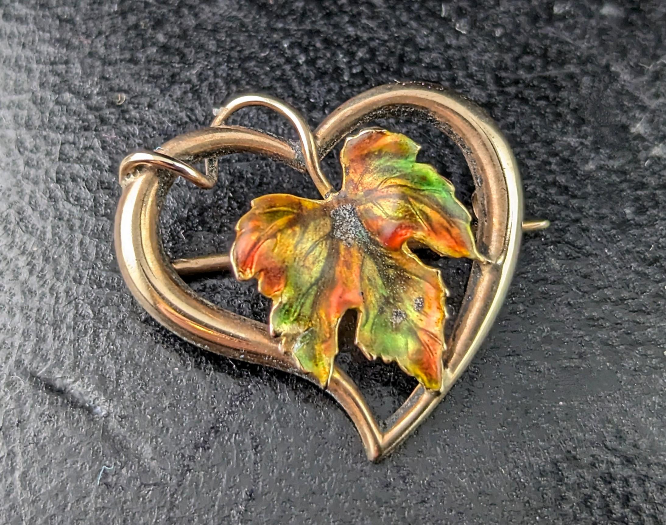 A beautiful Antique Victorian 'witches' heart brooch.

This gorgeous piece features a witches style hearts in rich 9ct gold, the heart encompasses a pretty maple leaf with rich autumnal colours.

A versatile piece could be worn many ways including