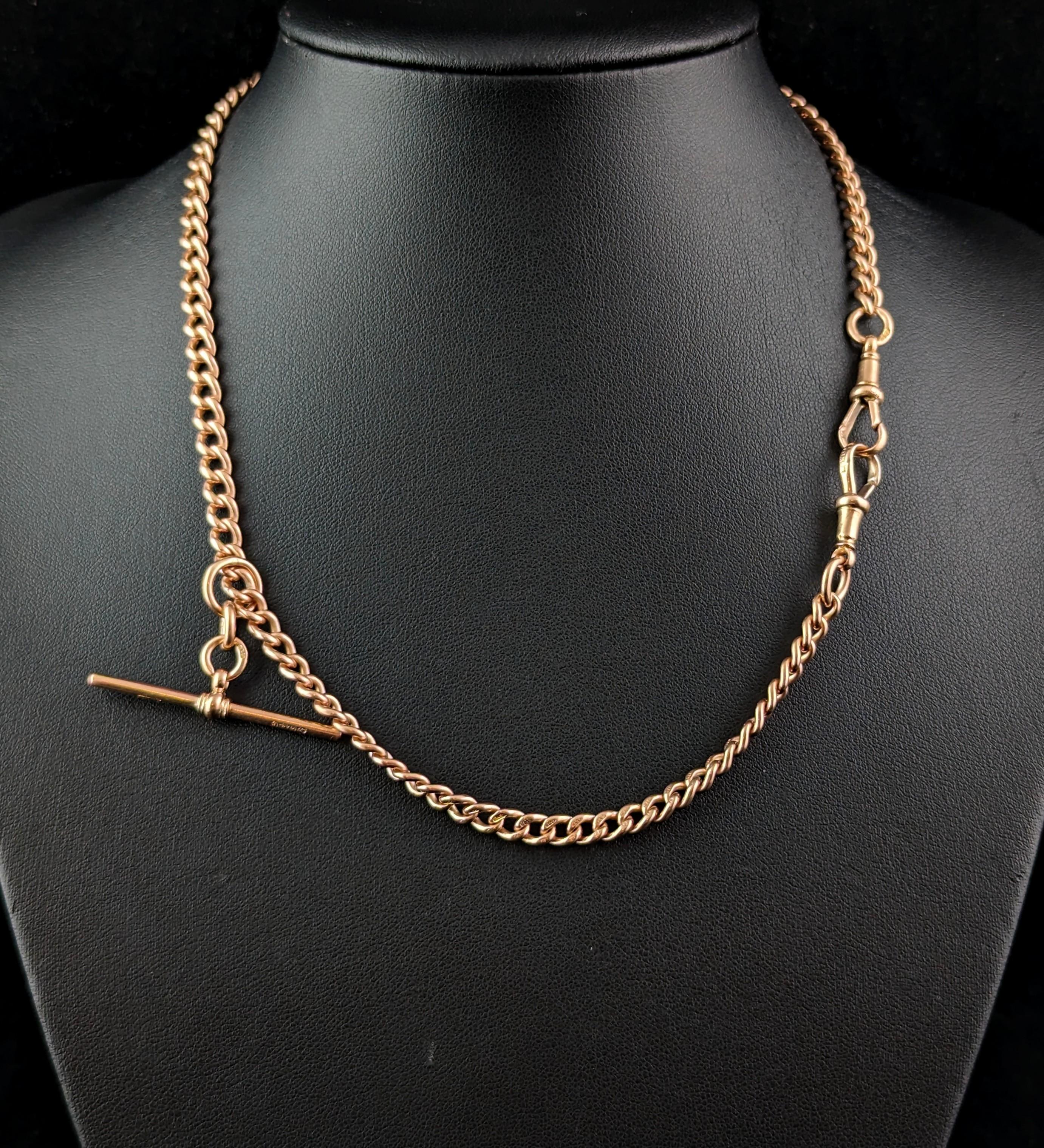 This magnificent antique 9ct rose gold Albert chain really has it all.

A lovely curb link chain in a warm Rose gold, each link individually stamped for 9ct gold, 9.375.

A double Albert with a uniform curb link it fastens with double gold dog clips