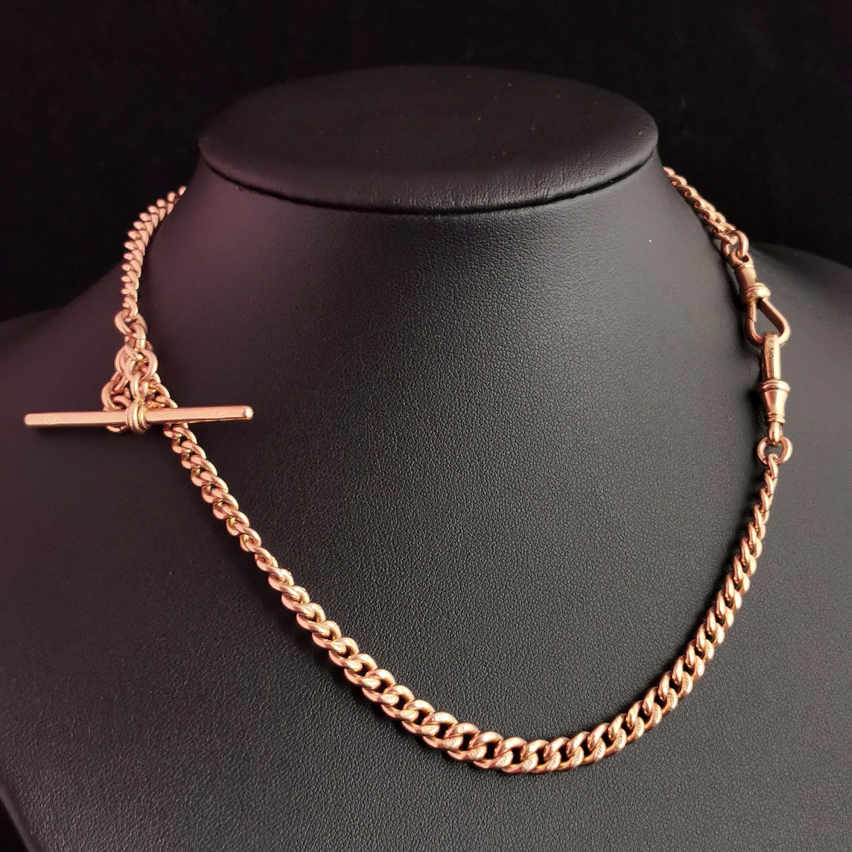 A handsome antique Edwardian era 9ct gold Albert chain.

It is a curb link chain in 9ct Rose gold, each link individually stamped for 9ct gold, 9.375.

A double Albert chain graduating in link width with a T bar and two dog clip fasteners.

A