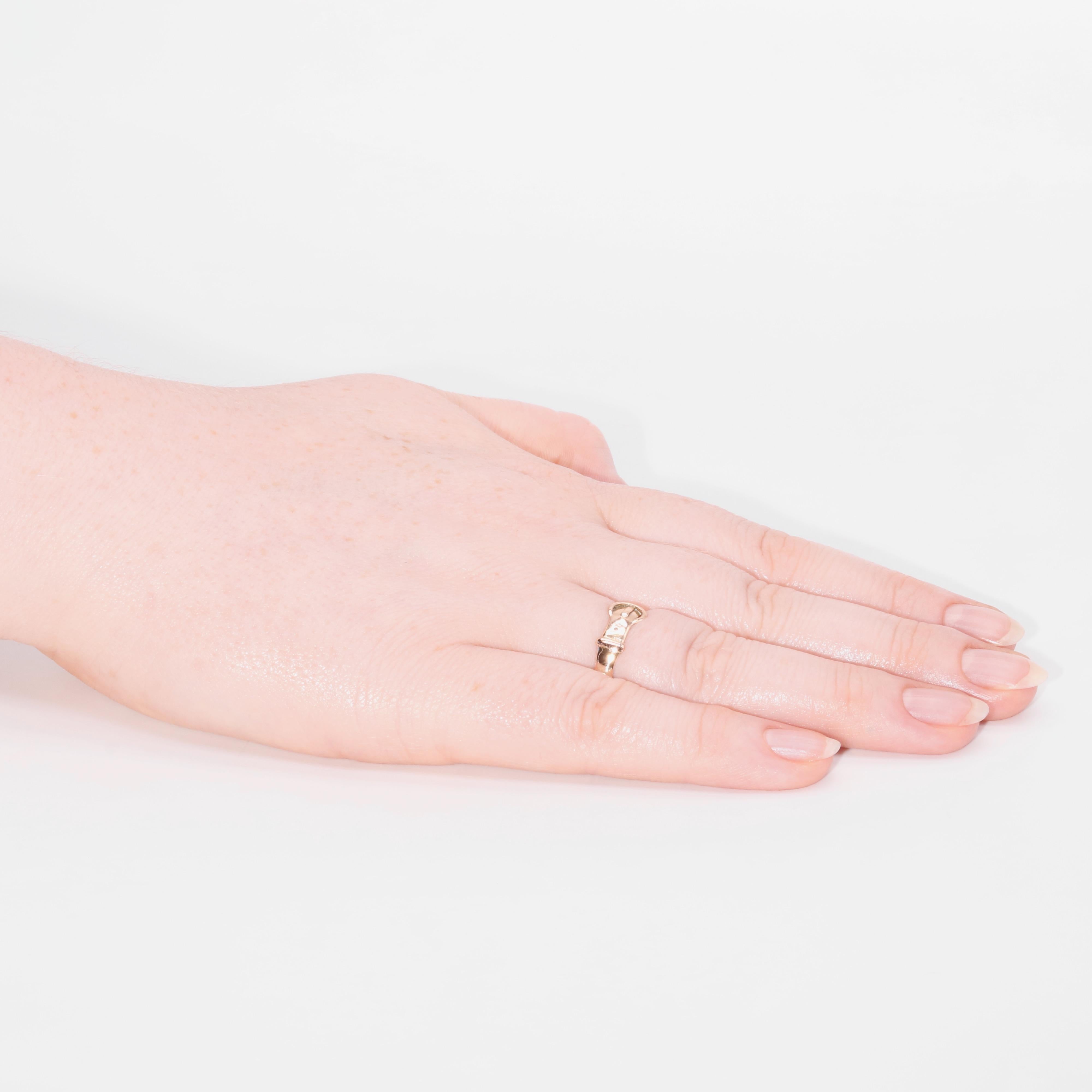 An antique rose gold ring, styled as a buckle, in 9 karat rose gold. 

A band ring, which is designed as a buckle, or belt, a design which was popular in the late Victorian and early Edwardian eras. The ring has been styled simply, as a plain,
