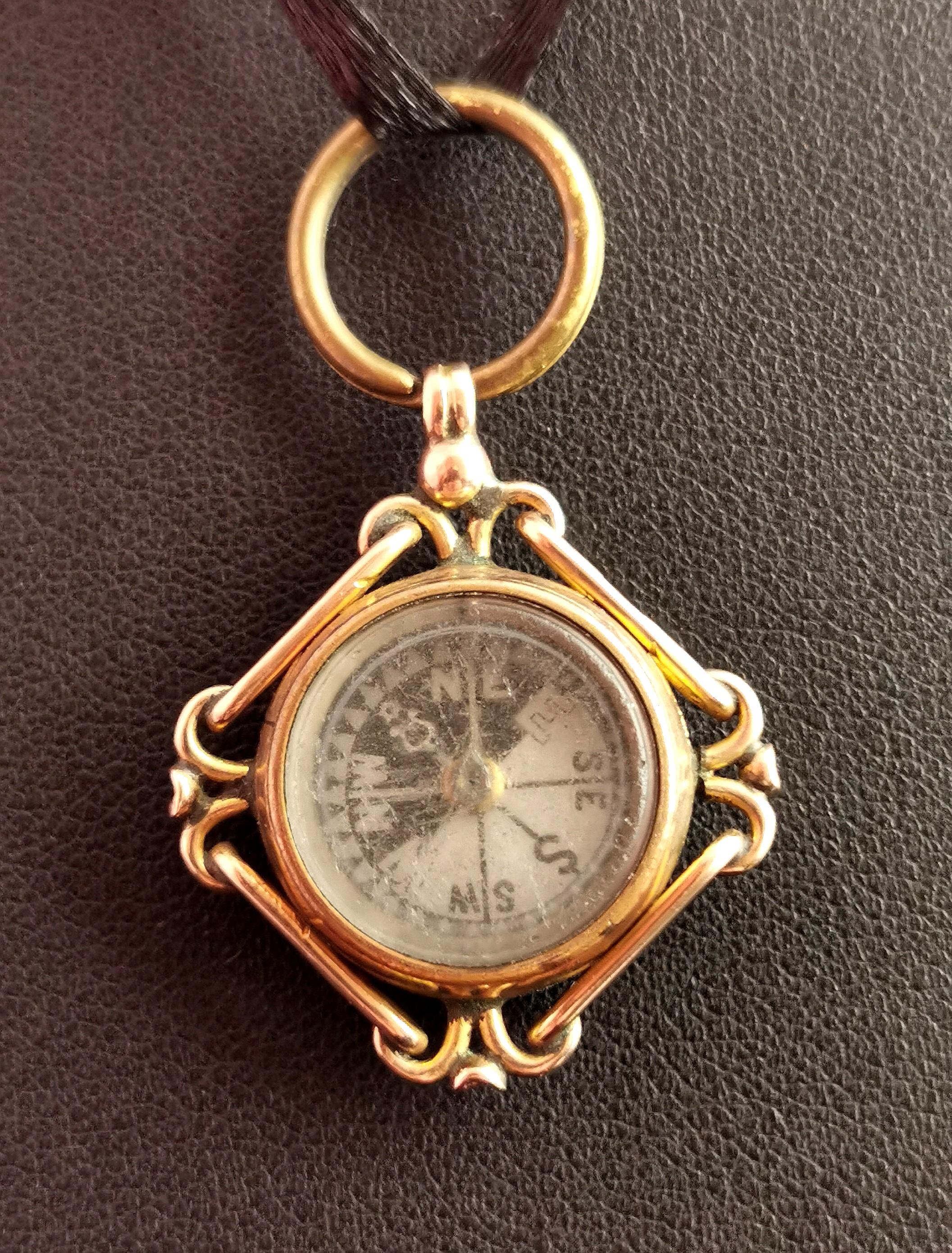 A beautiful antique 9kt gold compass pendant or fob.

It has a Carnelian stone set to one side which has not been engraved and is a smooth polished deep red.

The other side features a compass which appears to be in working order though I can't