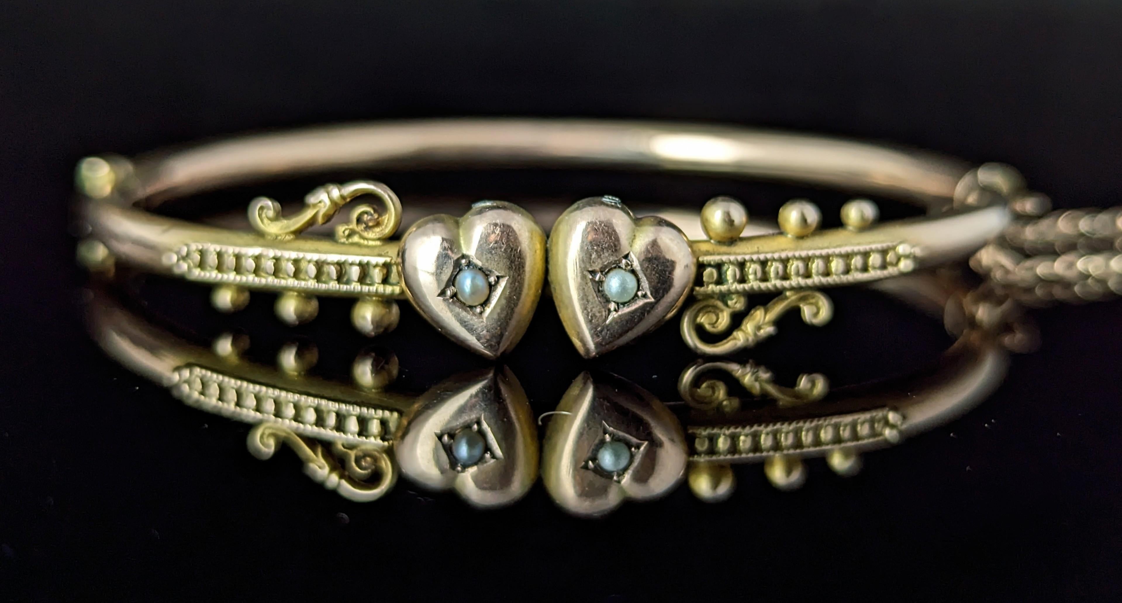 We love a good antique bangle here and this Beautiful Edwardian 9ct Rose gold, Double hearts pearl bangle is no exception.

It has a gorgeous classic design, a slim rose gold band with a pair of pearl set love hearts to the front along with