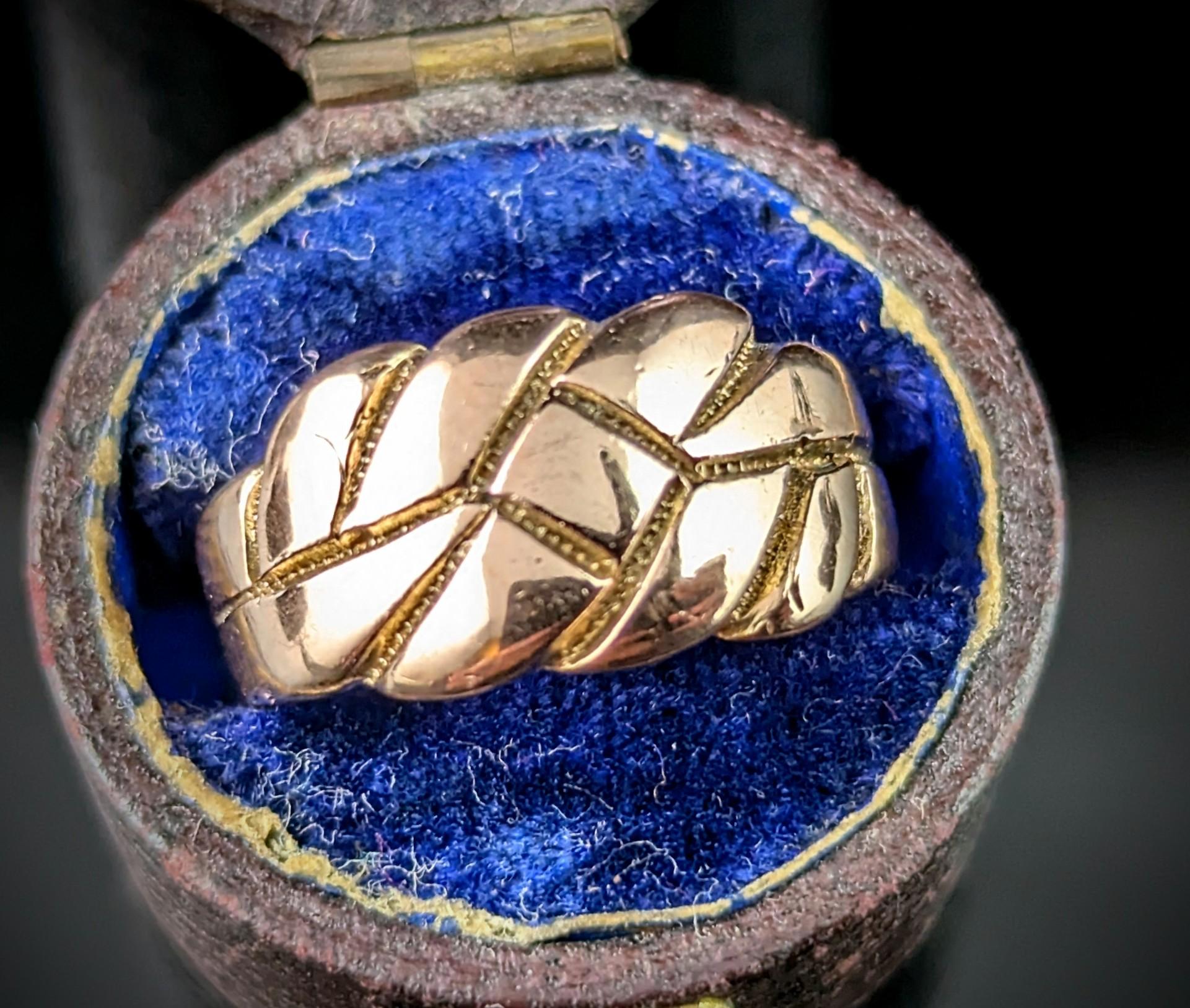The keeper ring is a classic and highly sought after ring style, this antique Edwardian era keeper knot style ring is a real charmer. 

The face is made up from a scrolling knot design engraved into the face. 

The ring is crafted in a rich 9ct rose