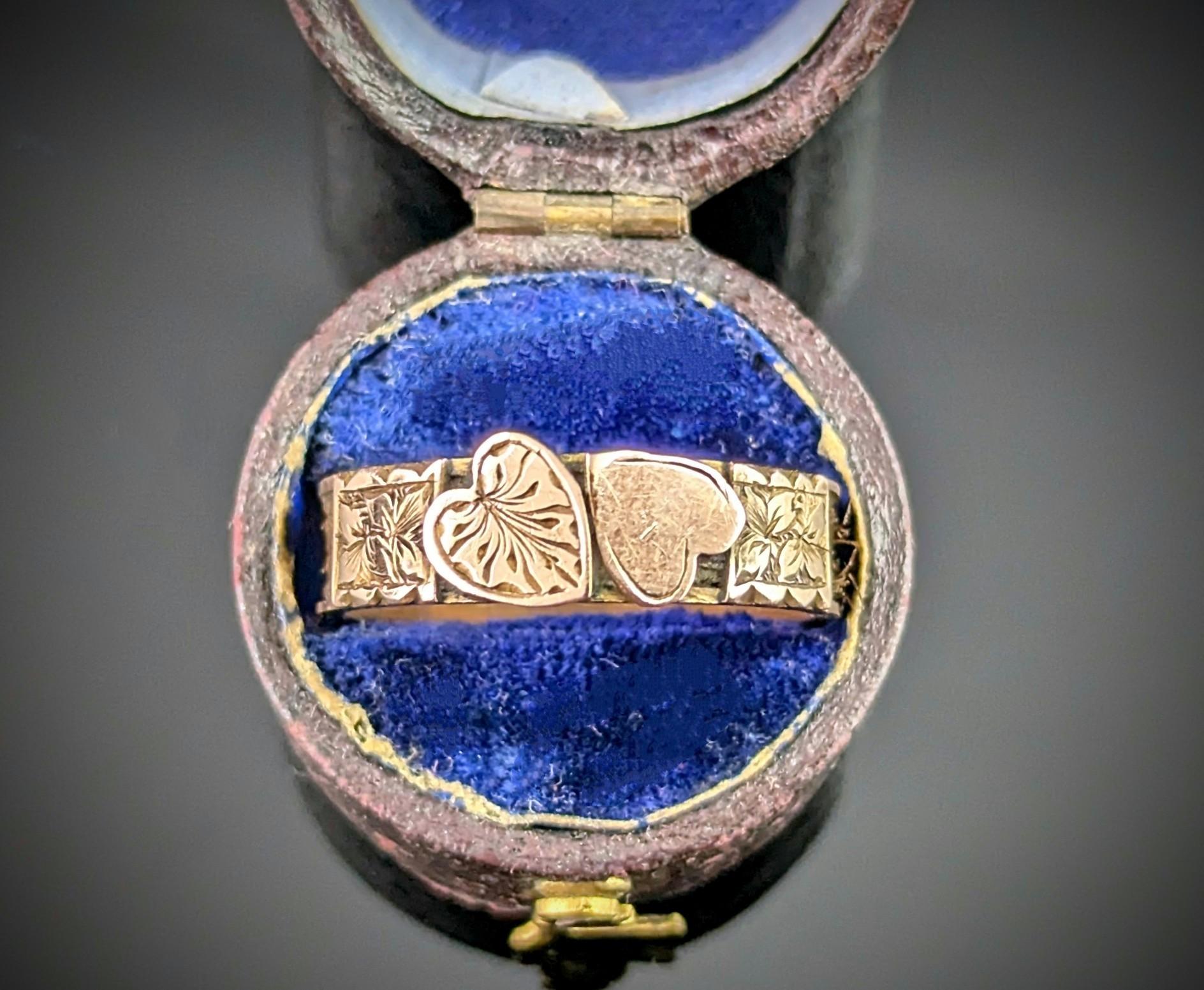 The sweetest antique mourning ring.

A rich rosey gold band with Hairwork woven into the band and secured with lovely engraved gold panels.

The front of the ring has the loveliest sentiment of double hearts, set together side by side, as a reminder