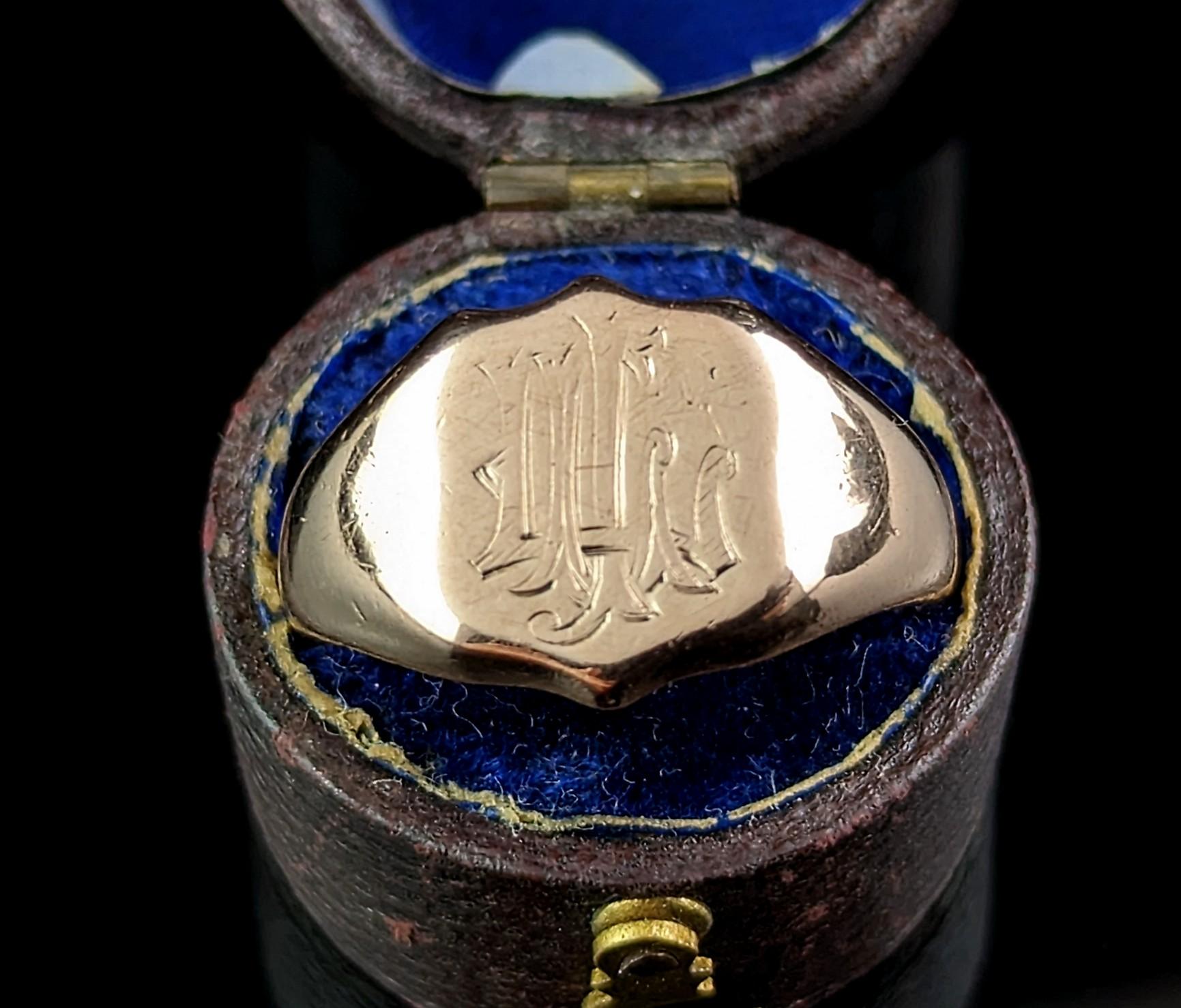 This handsome antique 9kt Rose gold signet ring has a warm cherished charm about it.

It has a shield shaped face with an engraved monogram of initials, this is a little worn but it could be LCI or similar in a gothic type script.

It has a rich,