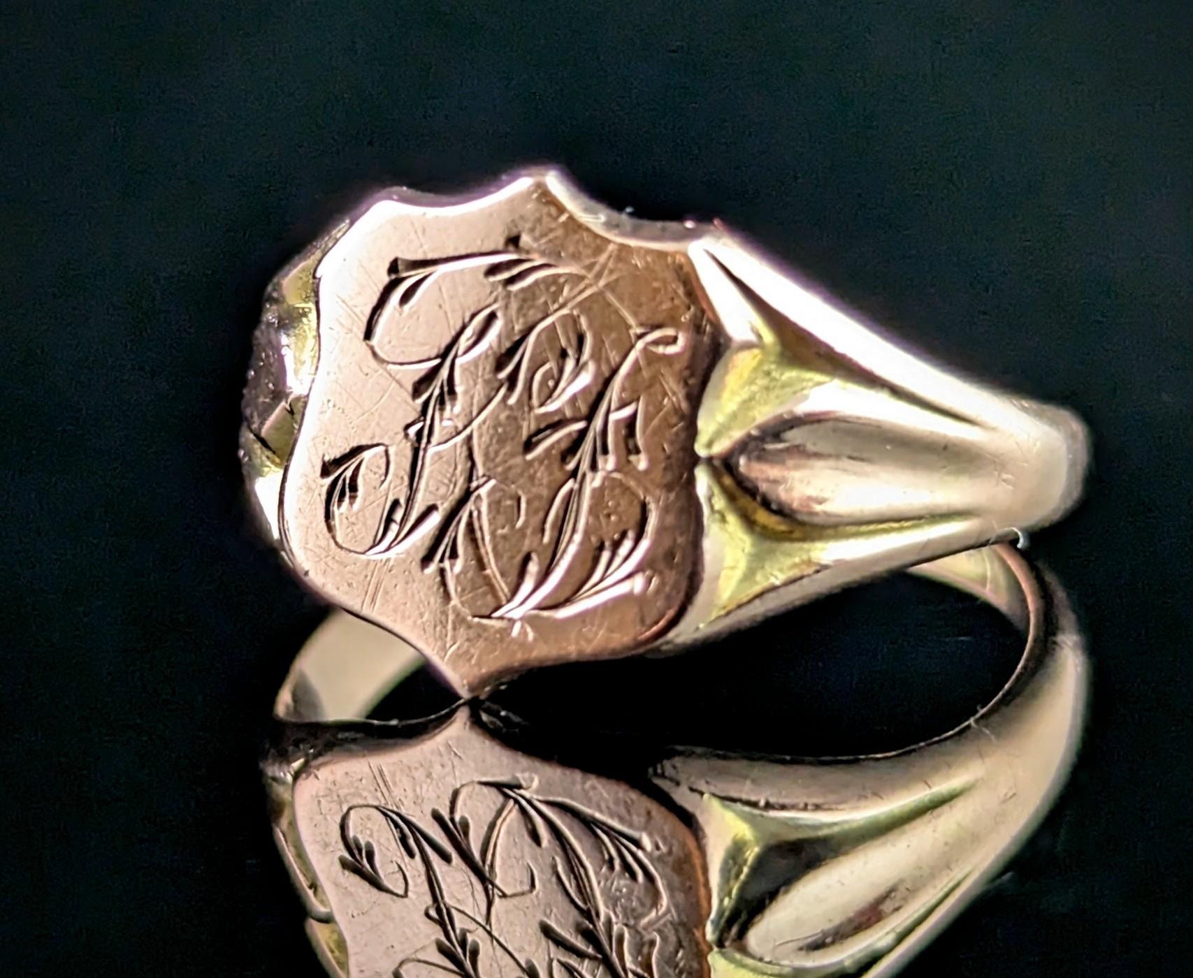 If you are looking for a classic antique signet ring then this one is for you.

A handsome design, this signet ring has a shield shaped face, with a monogram to the front in fancy script, the letters appear to be K L or K B but are difficult to