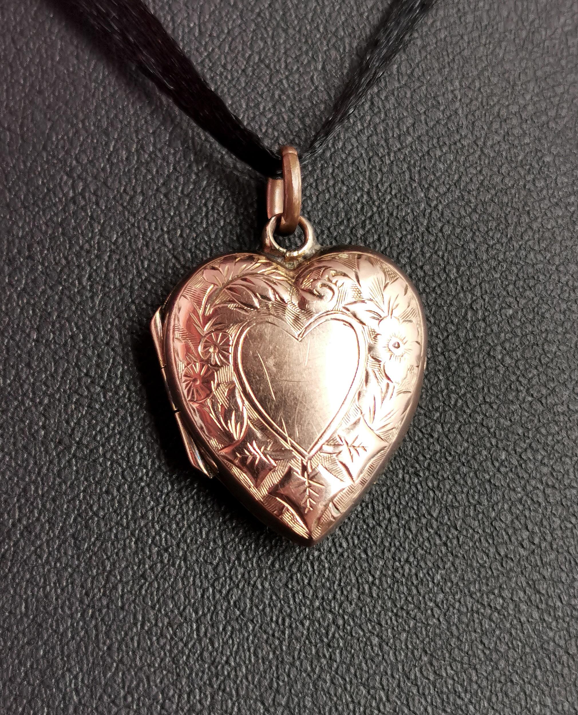 A sweet little antique 9kt gold heart shaped locket pendant.

Edwardian era it has an elaborately engraved front with ivy leaves and flowers, there is a plain polished heart in the centre which has not been engraved so could be personalised if