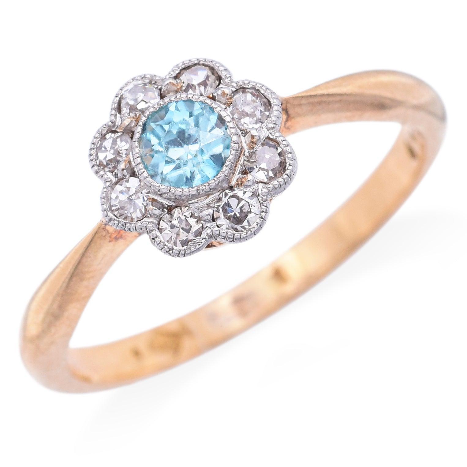 Antique ring signed A.H., featuring a vivid blue zircon accented with sparkling diamonds. The zircon and diamonds are set in platinum, while the gallery and shank are crafted in warm 18K yellow gold, creating a refined two-tone design. Delicate in