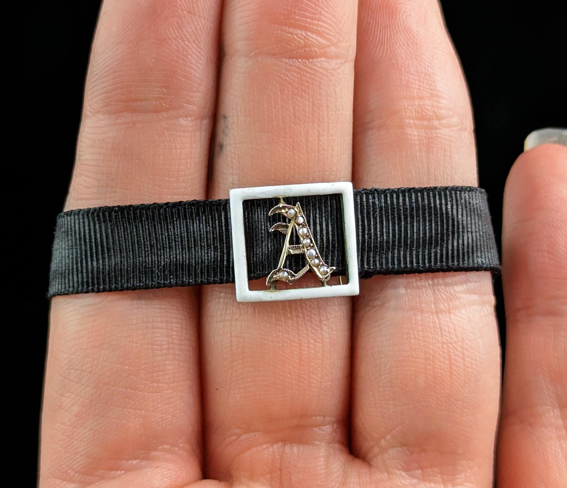This sweet little antique slider bracelet is so pretty!

It is a small sized black silk bracelet, probably a child's bracelet with a 9ct yellow gold clasp.

It has an attached slider made from 9ct gold with the initial A to the centre, it is