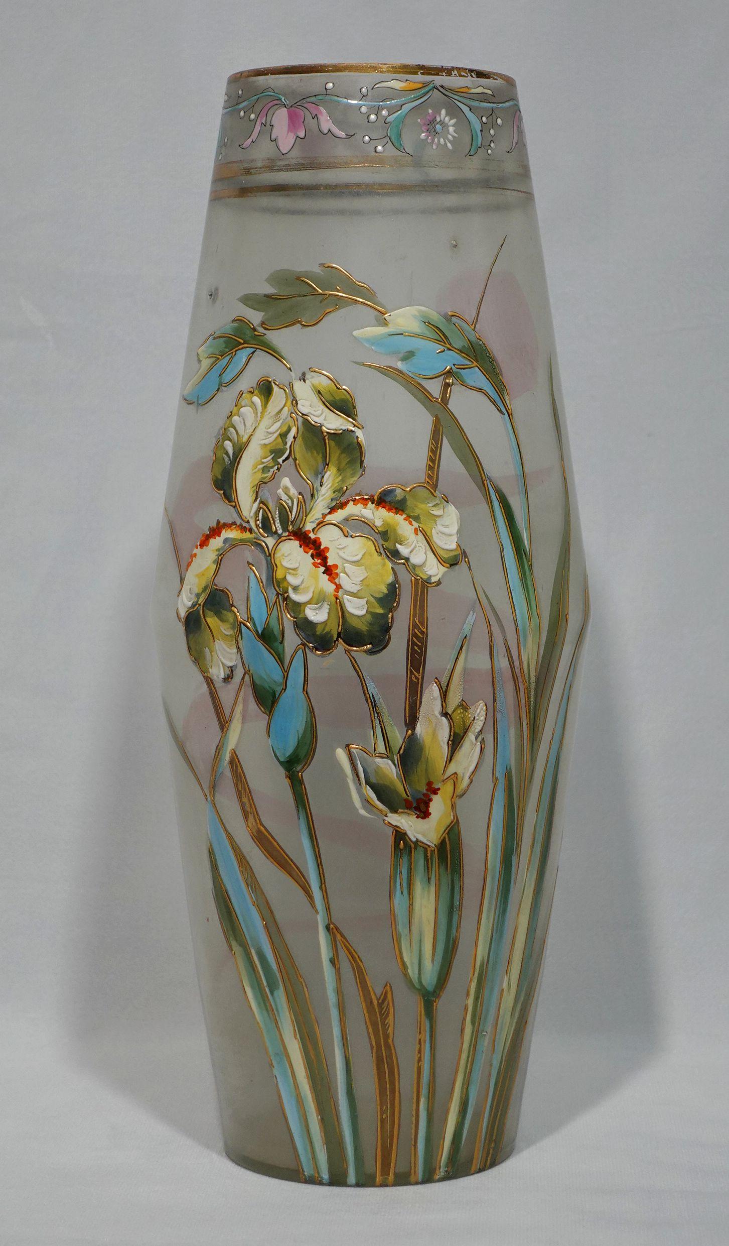 This is an exceptional example of early French Mont Joye art glass. It is Circa 1910. The vase has a floral enameled motif in the form of pansies leaves, and gold rims. The pansies have a deep rich vibrant color and are accented by an intricate gold