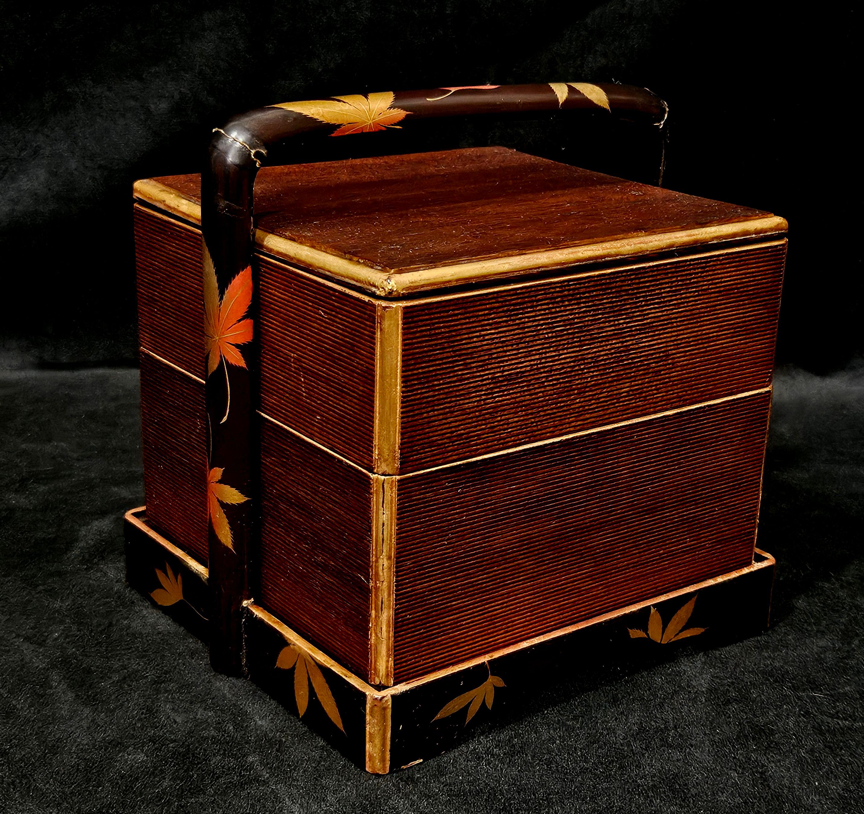 Two-tier bento box in holder with carry handle, with gilded leaf decoration, 6 1/2