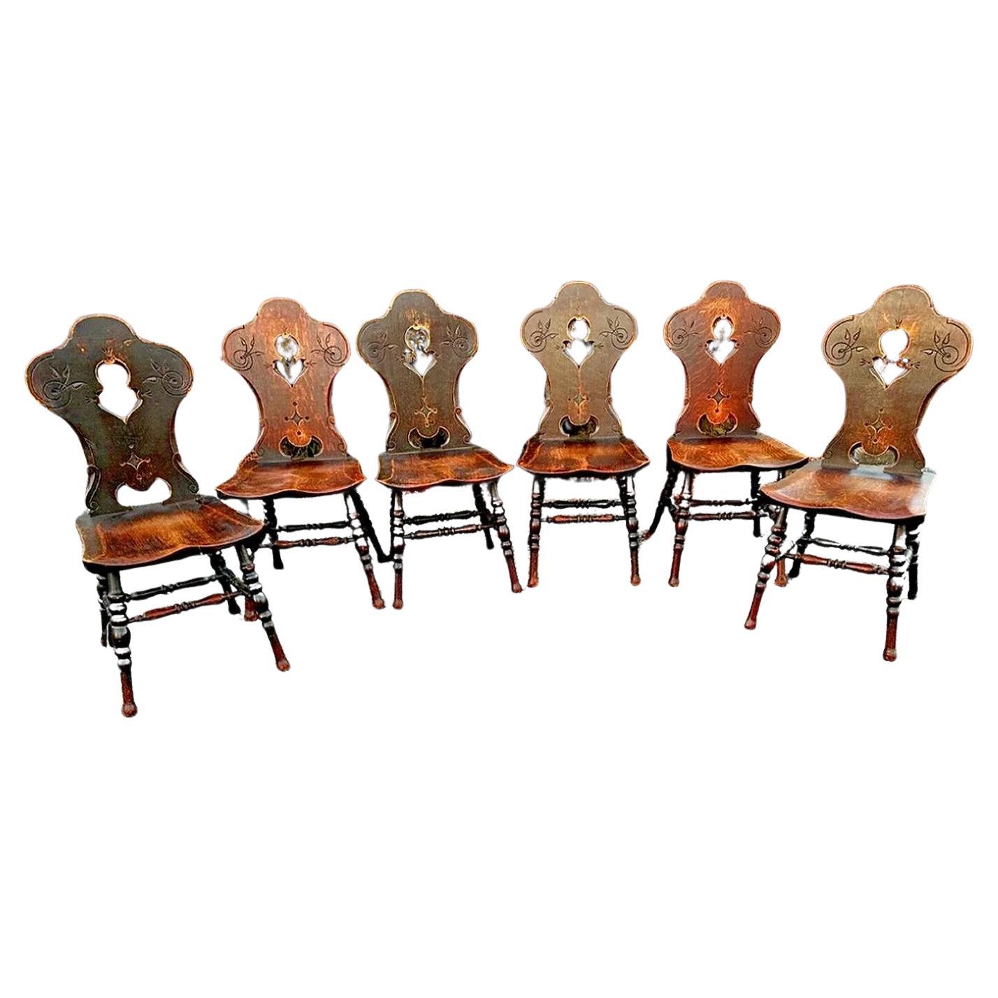 This is a beautiful set of 6 dining chairs from the early 1900s in the style of Charles Limbert.  These chairs are in excellent condition. There are no repairs or cracks and no replaced parts. The set comes with GREAT fumed black color and a superb